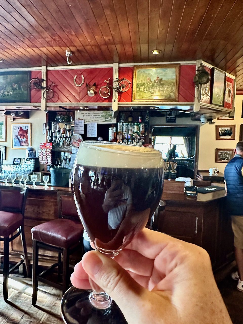 Irish coffee with whipped cream in a glass held in a pub