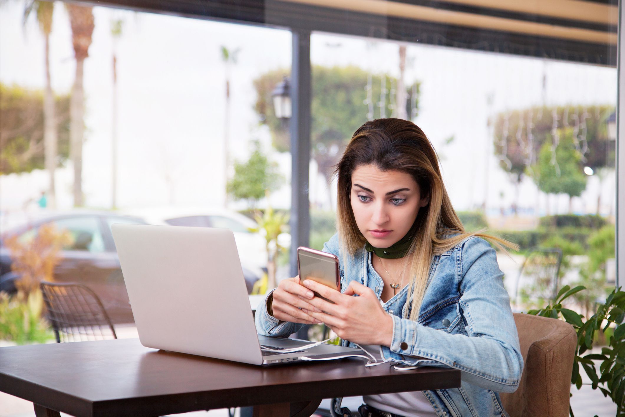 woman looking skeptically at phone