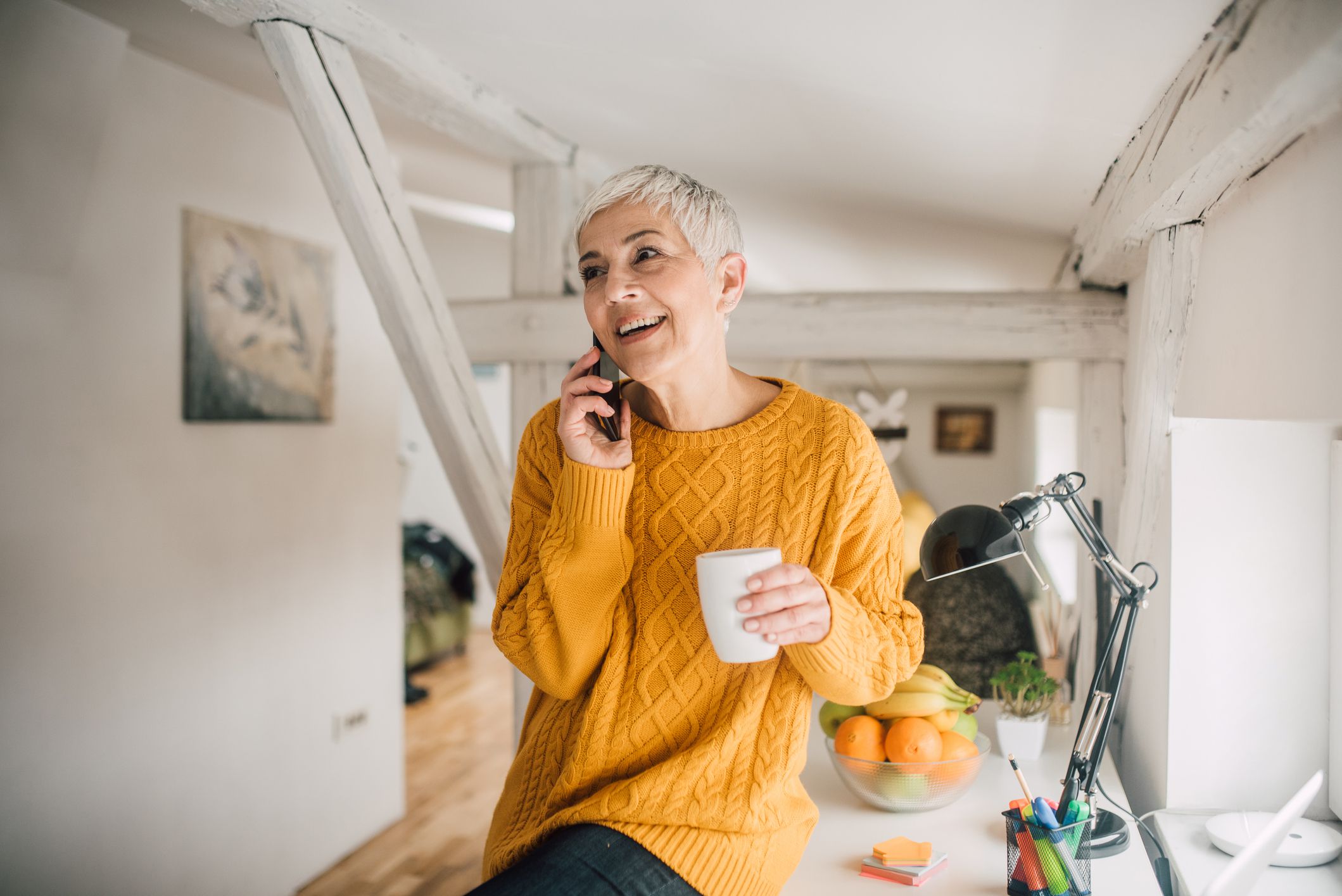 Happy older woman using mobile phone and smiling