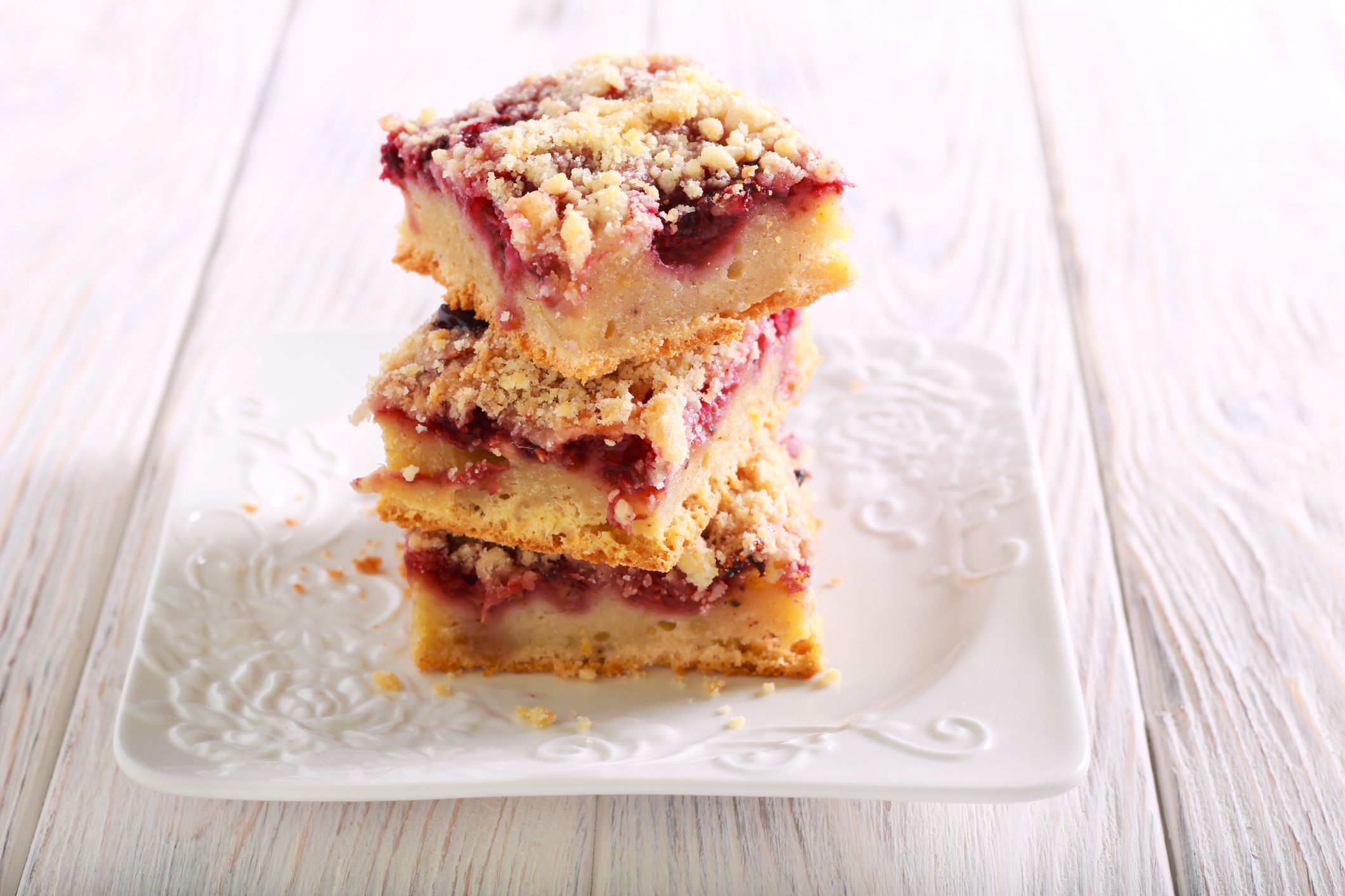 Raspberry crumble bars on plate, selective focus