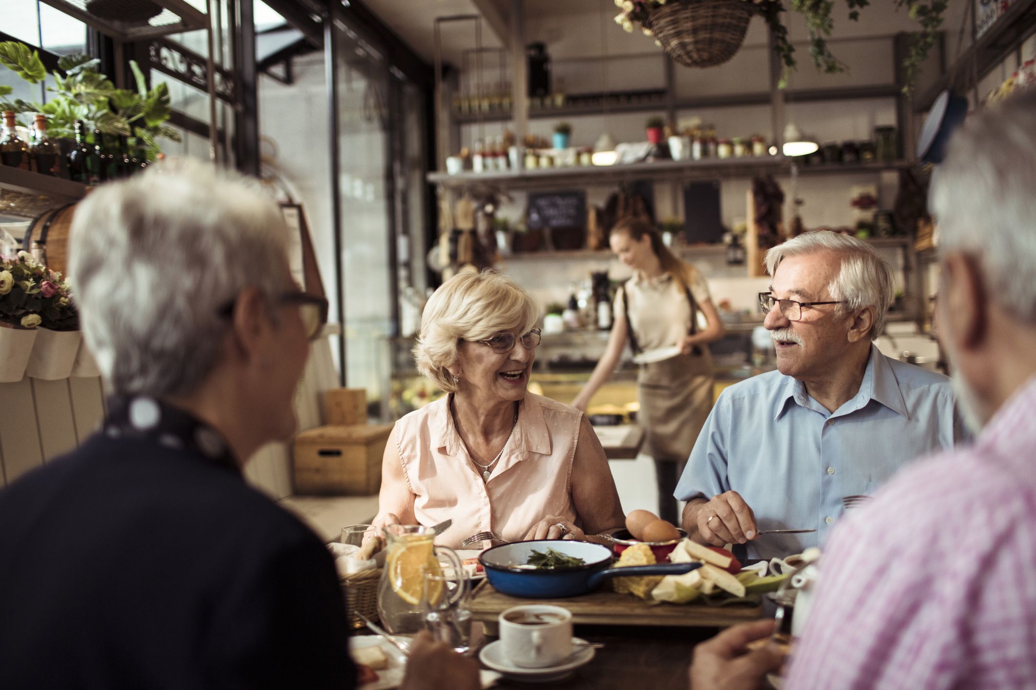 Close up of a group of seniors enjoying food in a restaurant