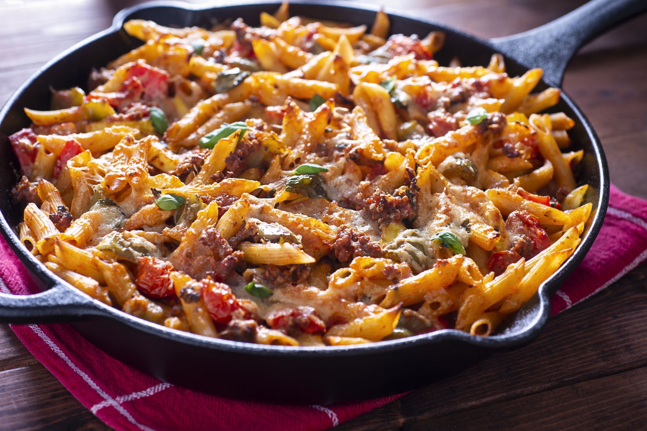 Healthy Pasta in Cast Iron Skillet with Tomato, Basil, Bell Pepper, Onion, Garlic and Parmesan Cheese