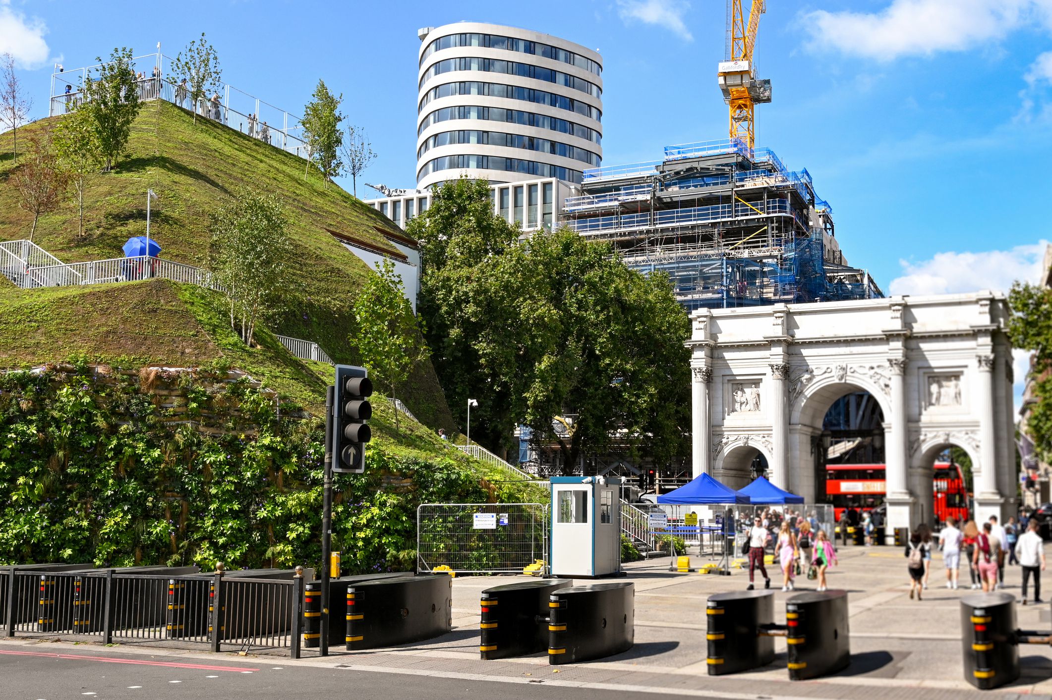 London, England - August 2021: The Mound, a temporary platform built with scaffolding and covered in grass supporting material to give visitors a view of Marble Arch and London.