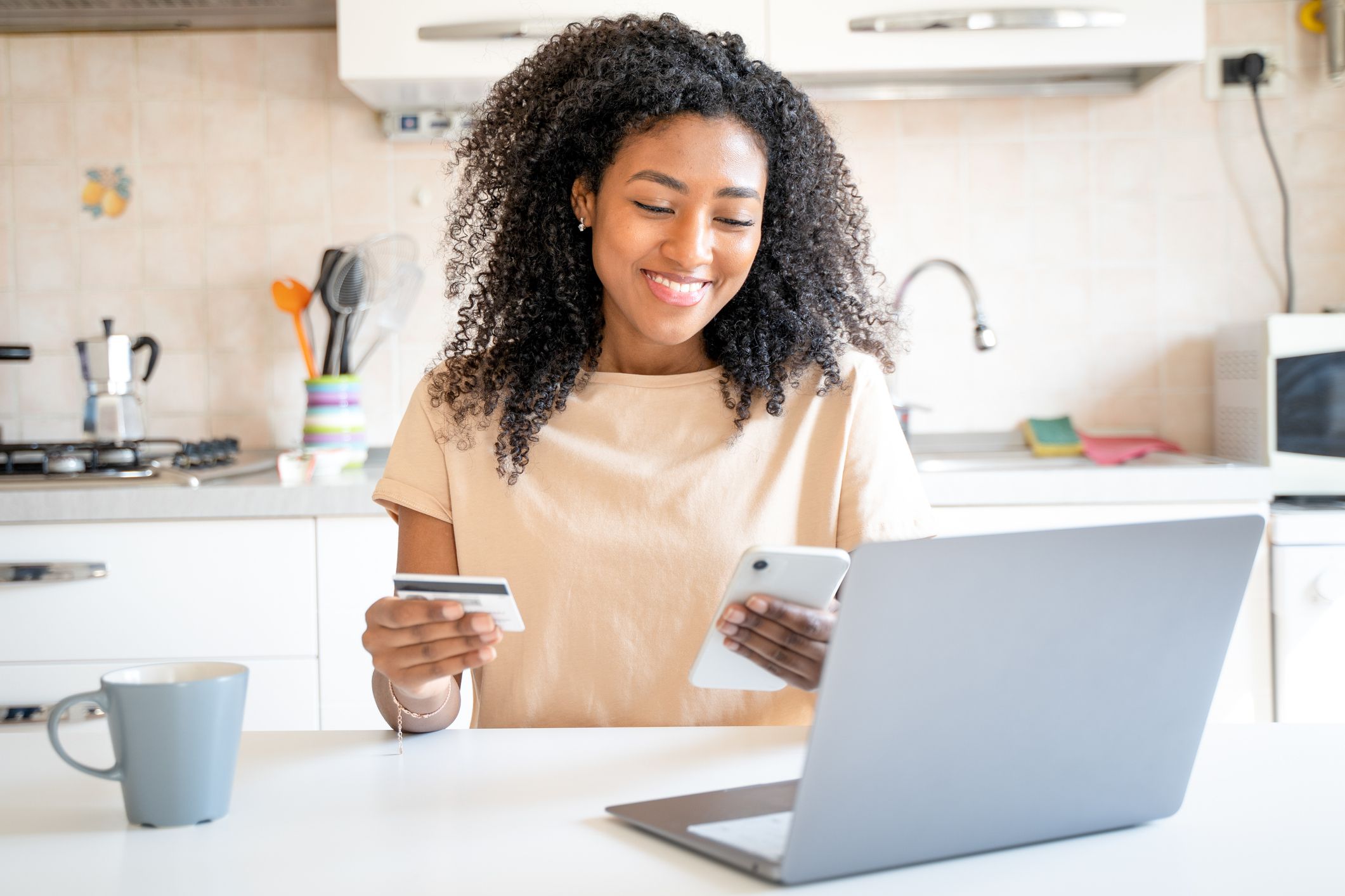 One confident black woman paying online using credit card