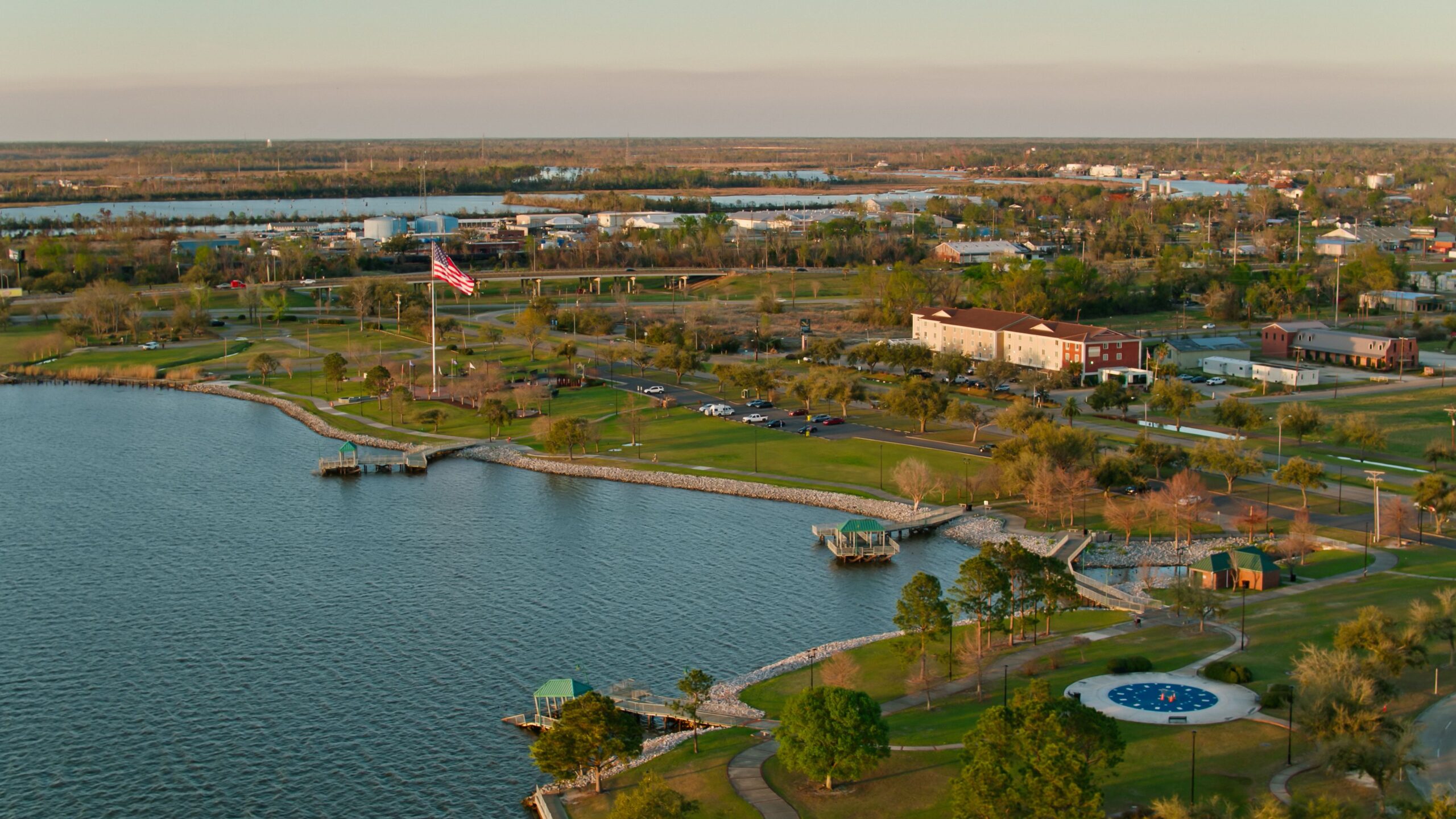 Aerial shot of US flag flying over Veterans Memorial Park in Lake Charles, a city in Calcasieu Parish, Louisiana. Authorization was obtained from the FAA for this operation in restricted airspace.