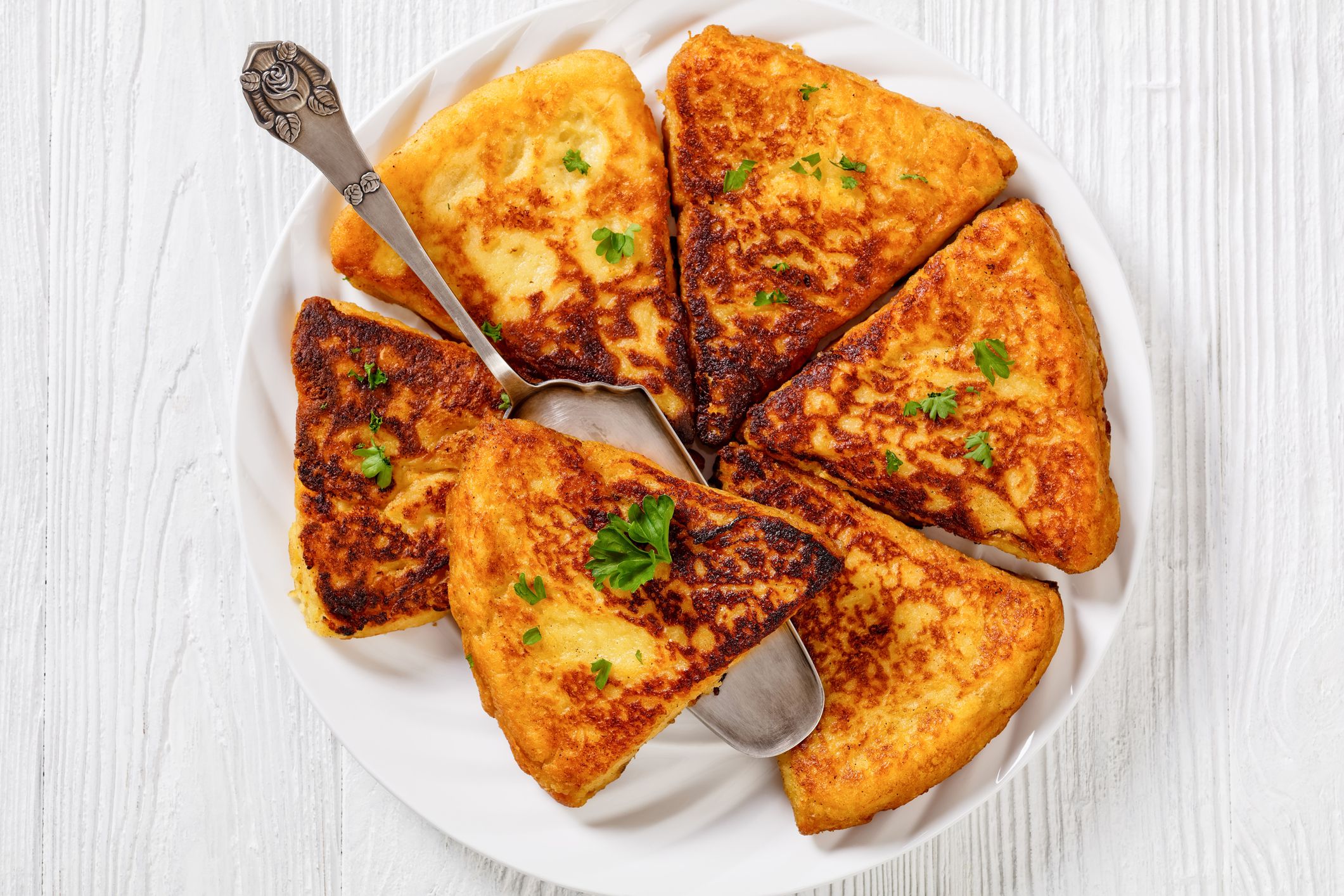 Potato Farls, Irish Potato Cakes, potato bread on white plate on white wooden table, flat lay, close-up