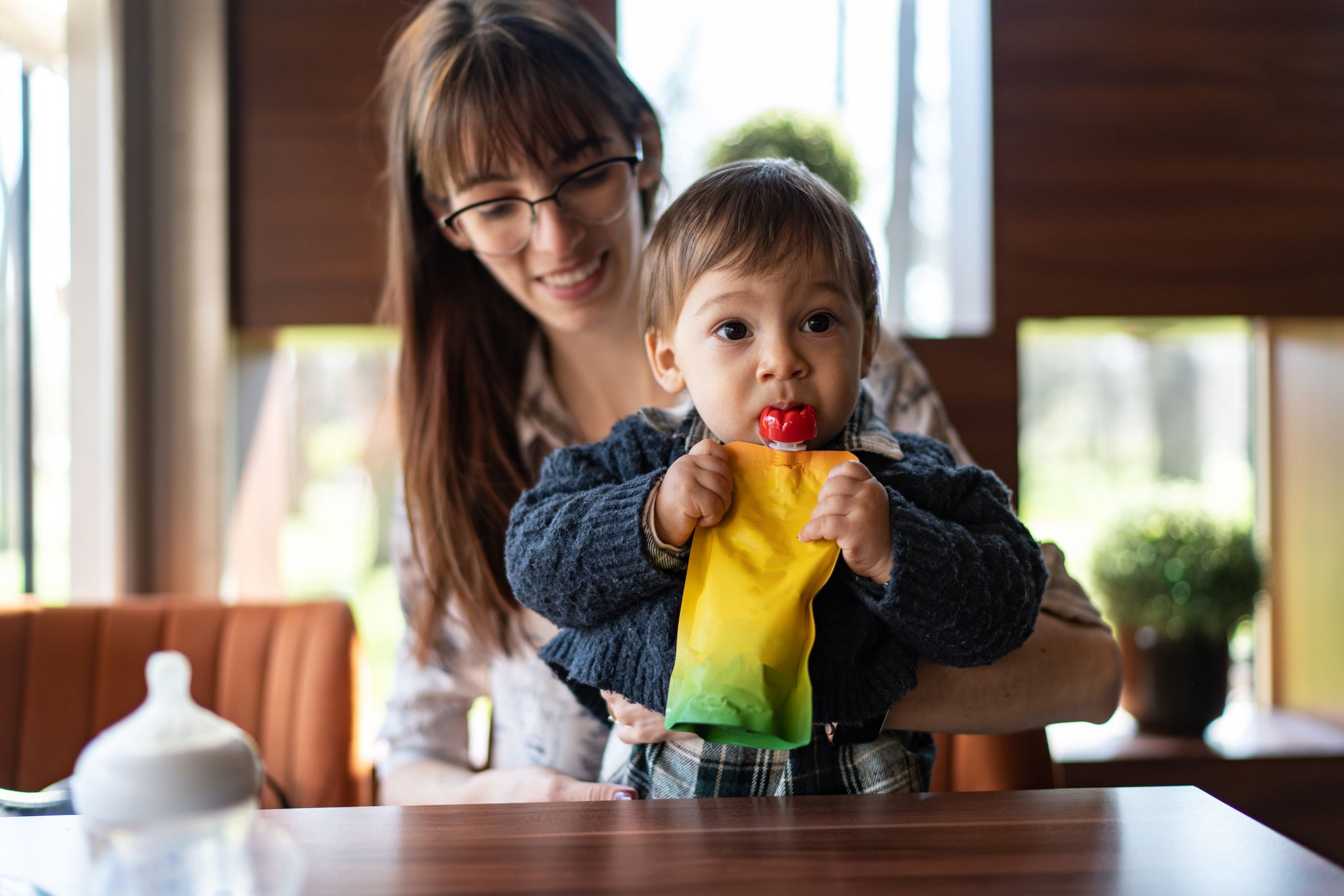Mother feeding her toddler boy