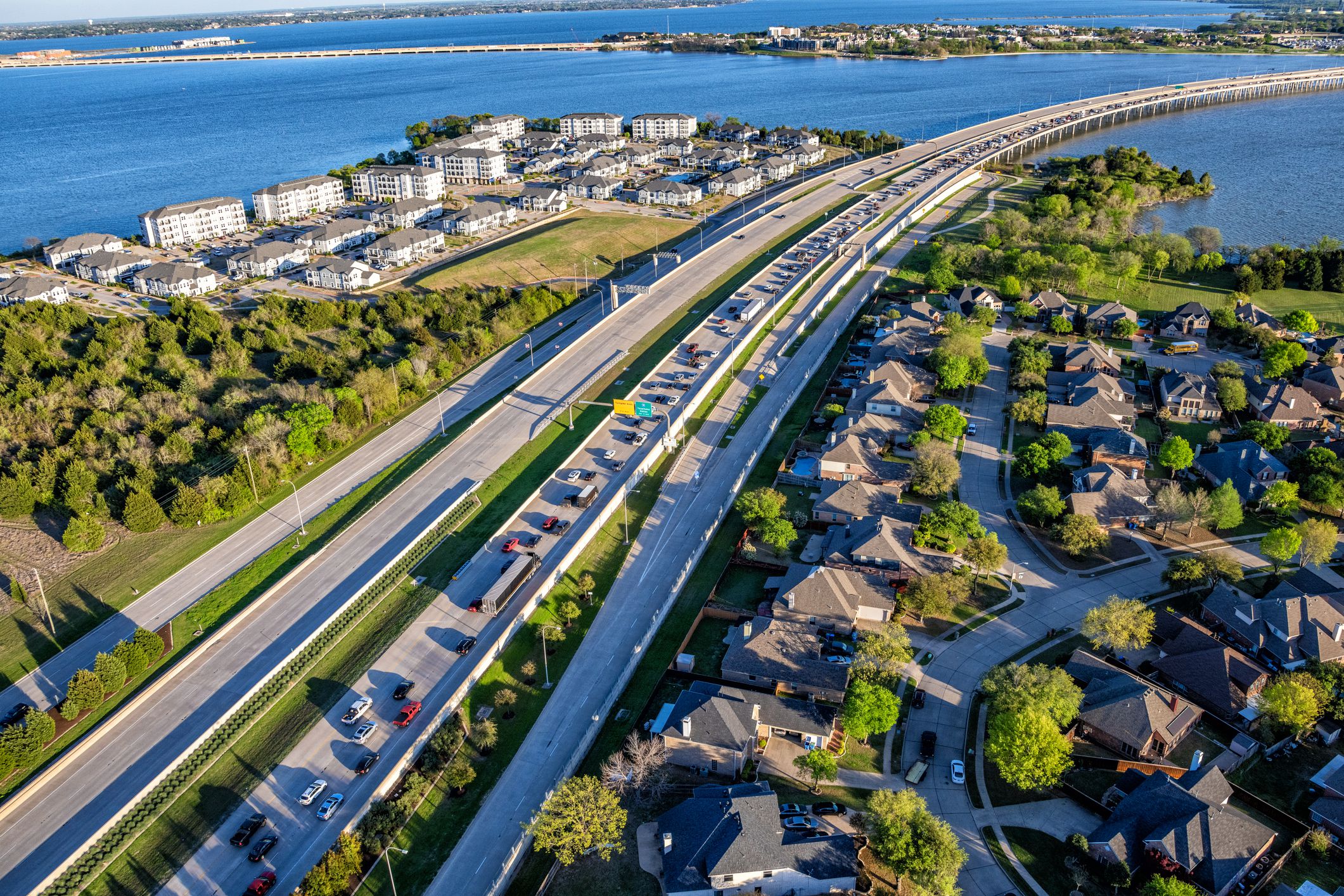 A freeway bridge at rush hour with traffic backed up heading north away from downtown Dallas, Texas on a spring evening shot via helicopter from an altitude of about 500 feet.