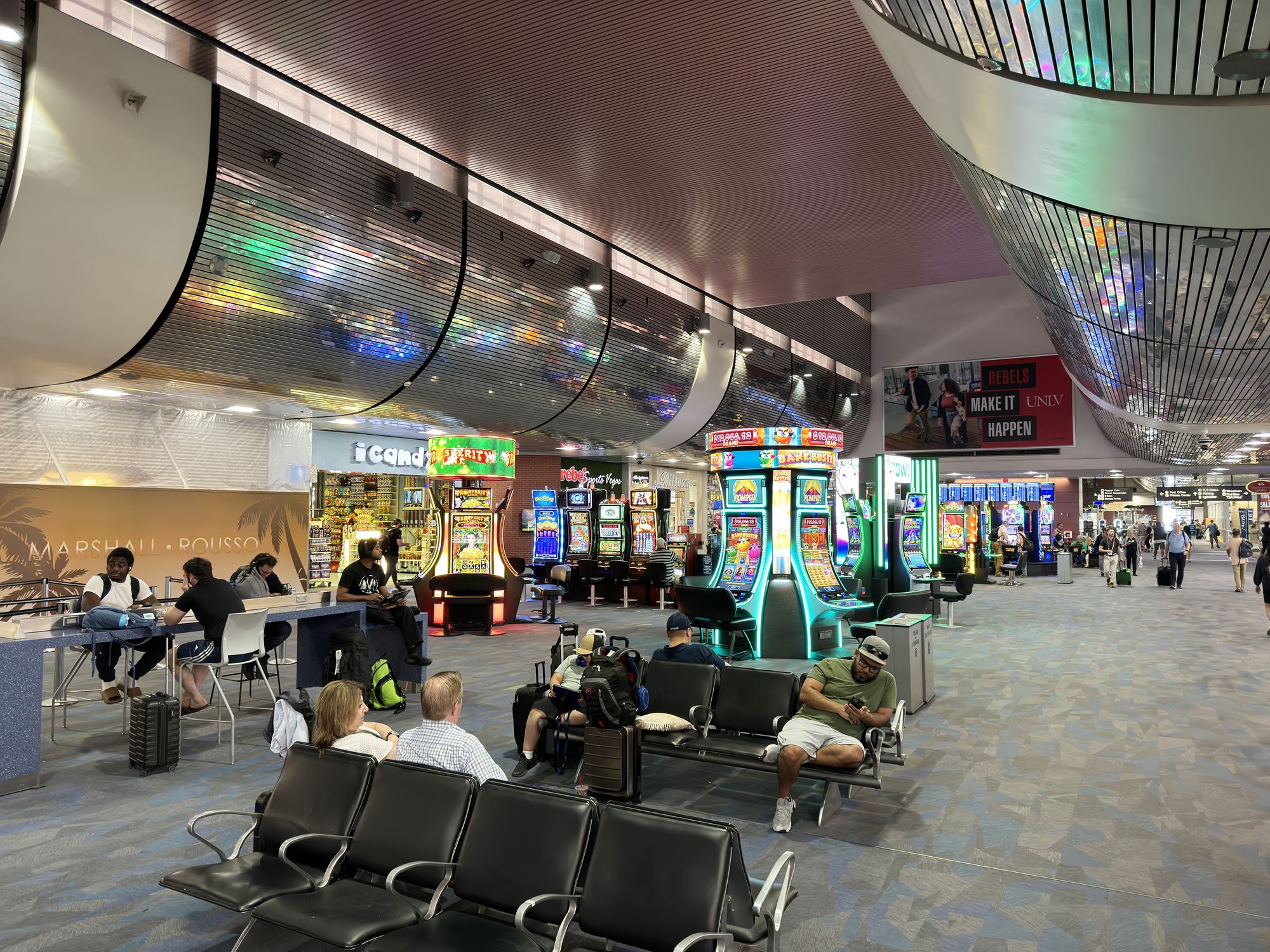 Las Vegas,Nevada,USA-June 11th 2024: travelers and slot machine inside Harry Reid International Airport