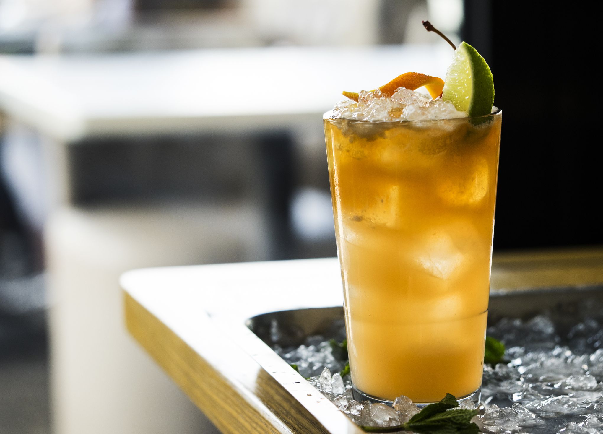 Close-Up Of Lemonade In Glass On Crushed Ice At Table