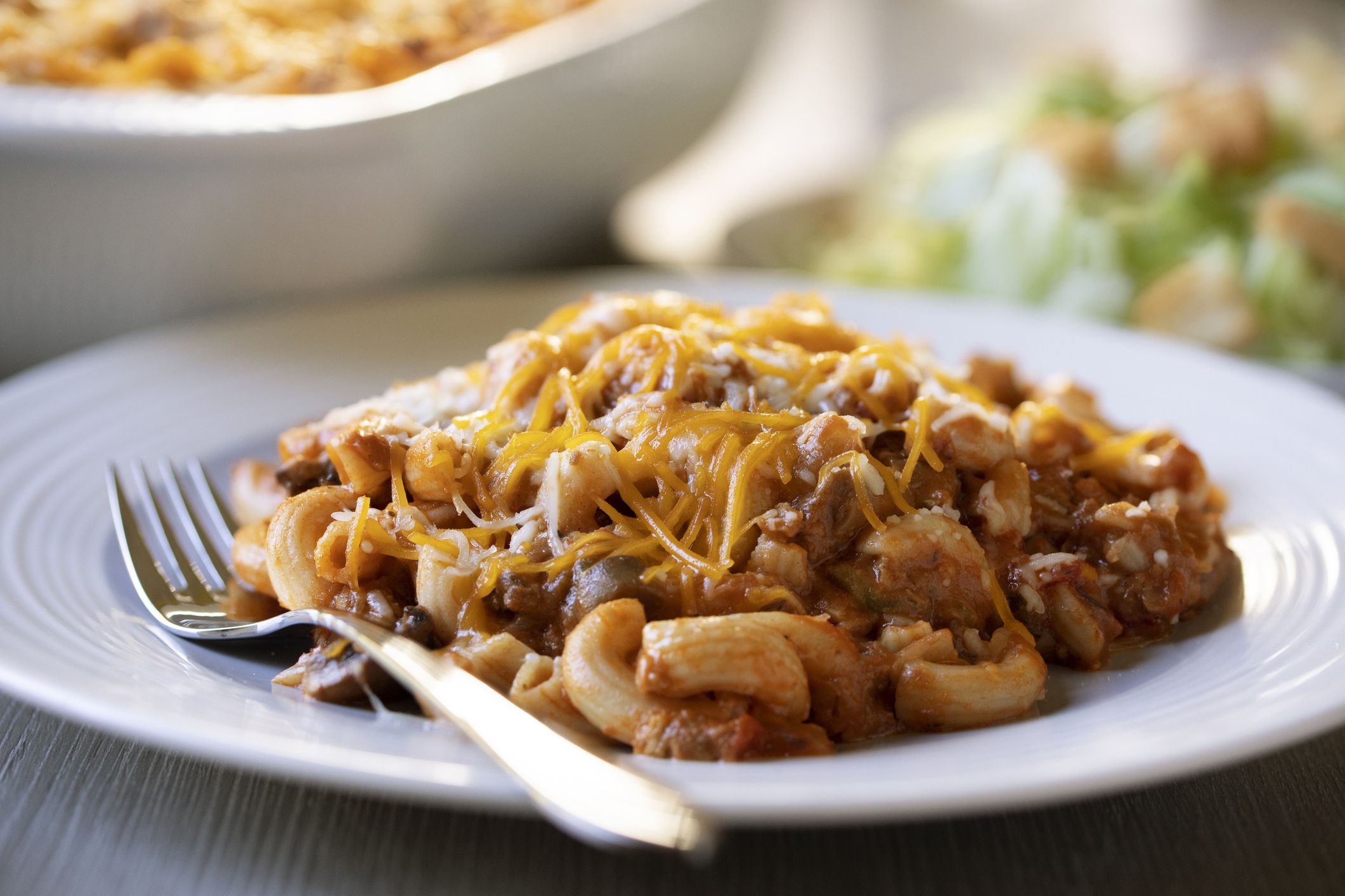 Ohio Tradition Johnny Marzetti Casserole, aka American Goulash, plated with a salad