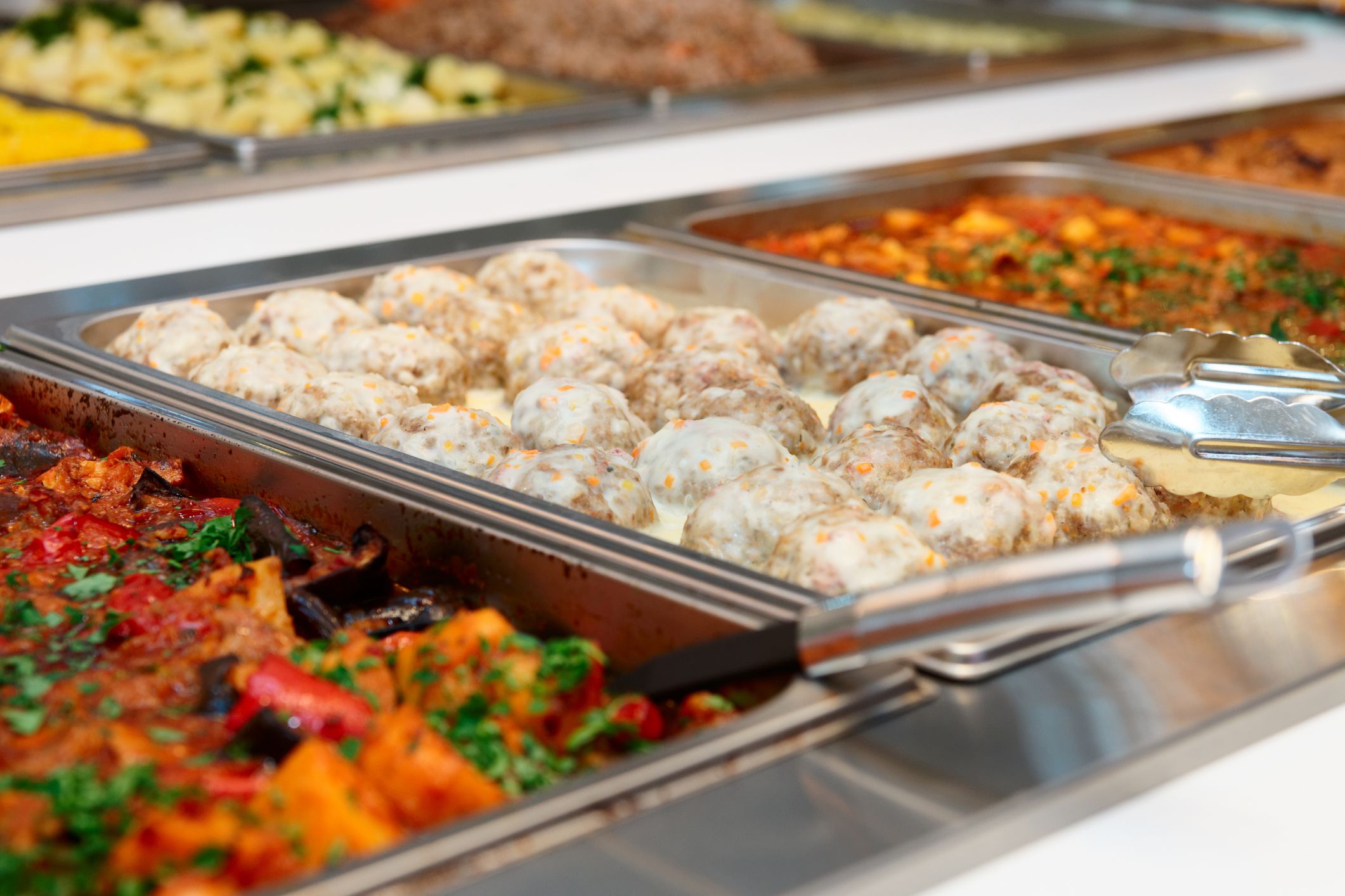 Meatballs and stewed vegetables in marmites