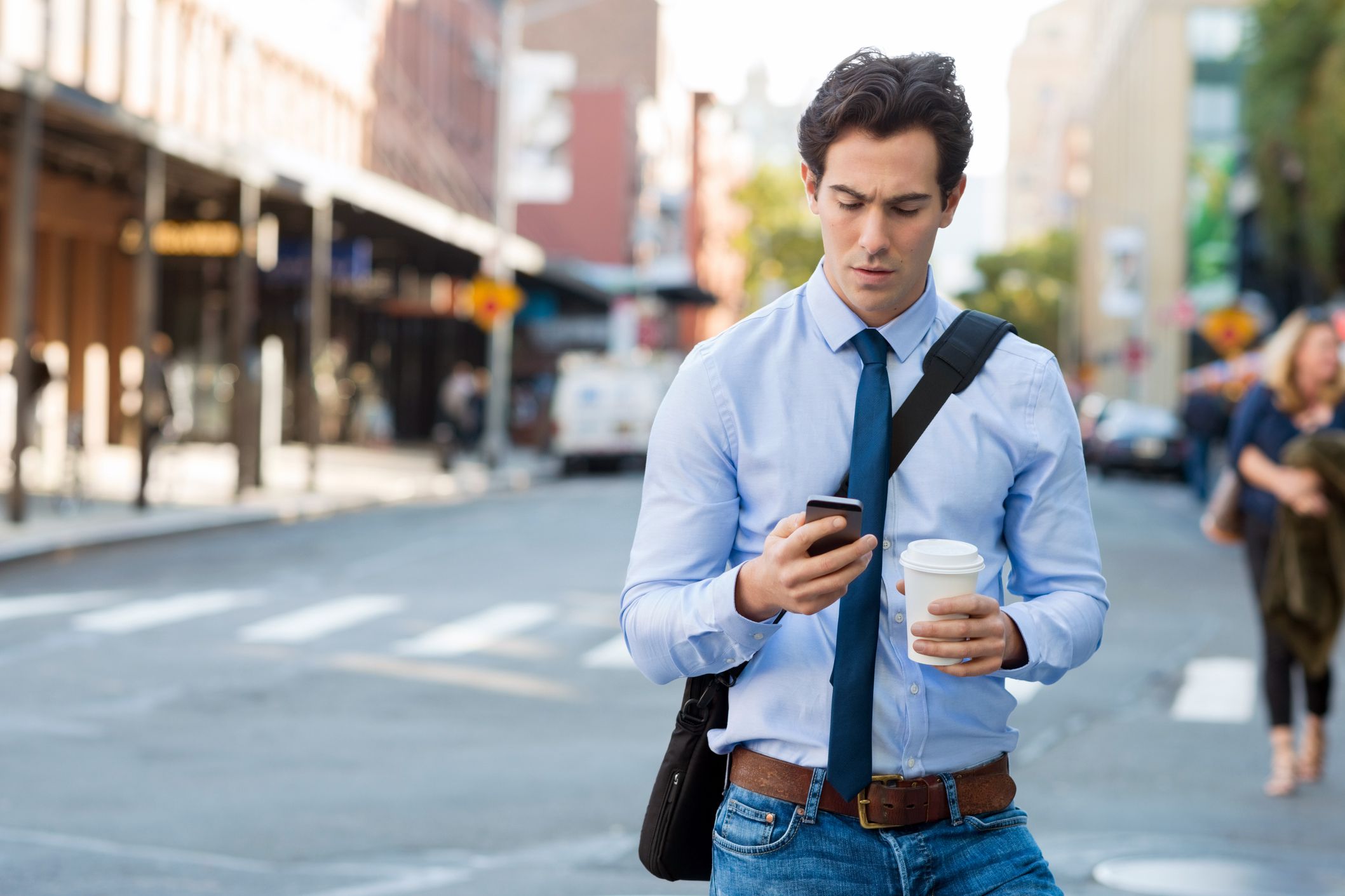 man looking at caller id on cell phone surprised about to answer call