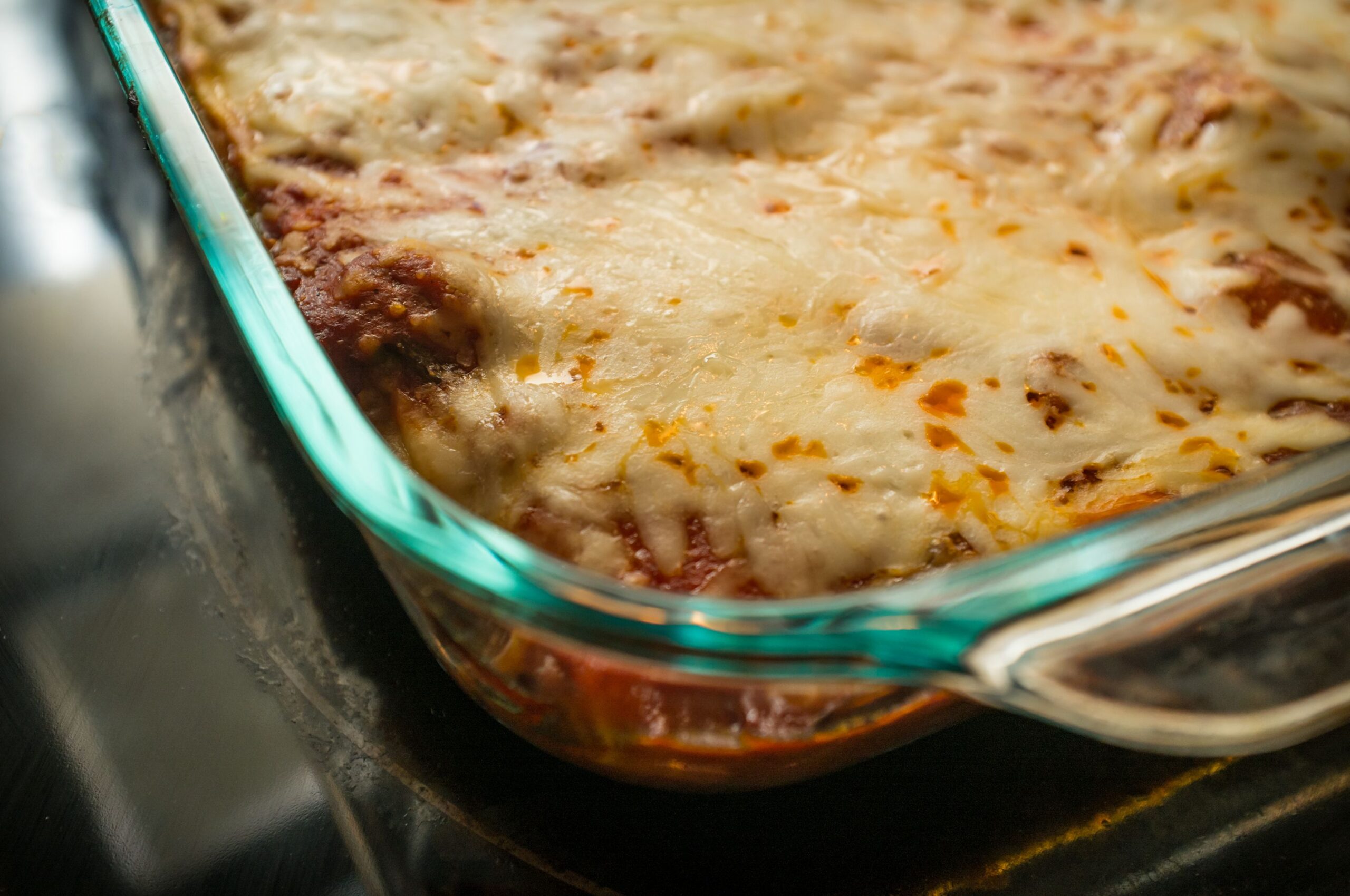 Close up delicious stuffed manicotti lasagna with mozzarella on top