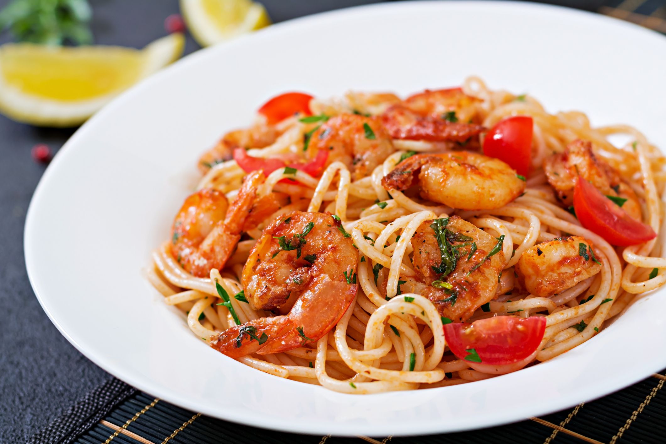 Pasta spaghetti with shrimps, tomato and parsley. Healthy meal. Italian food.