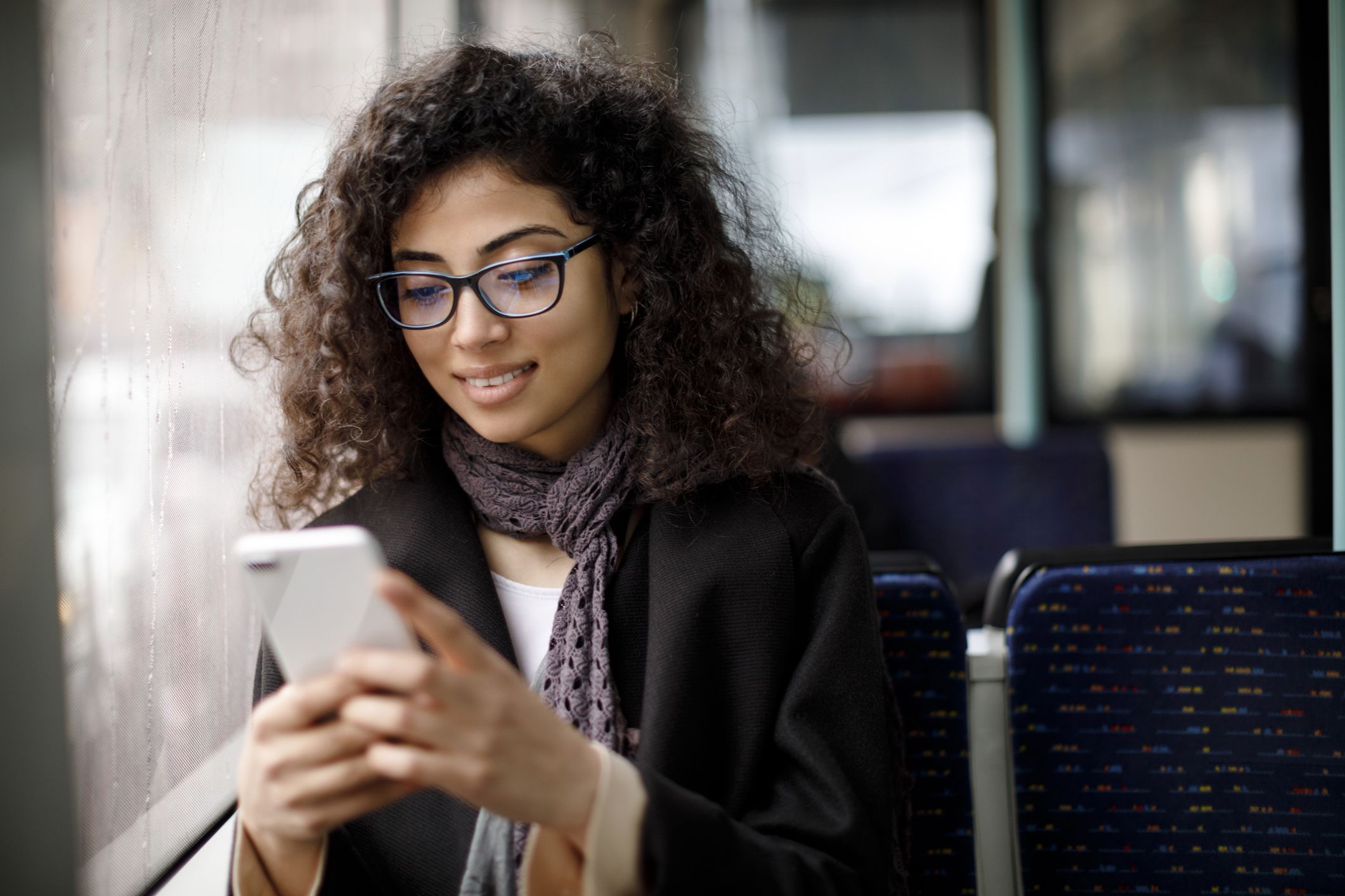 smiling young woman looking at phone