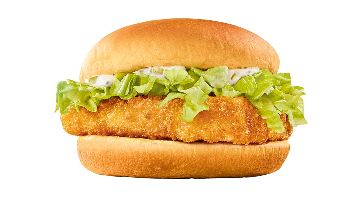 A crispy breaded fish fillet sandwich with fresh green lettuce and creamy tartar sauce in a soft, golden hamburger bun, against a white background.