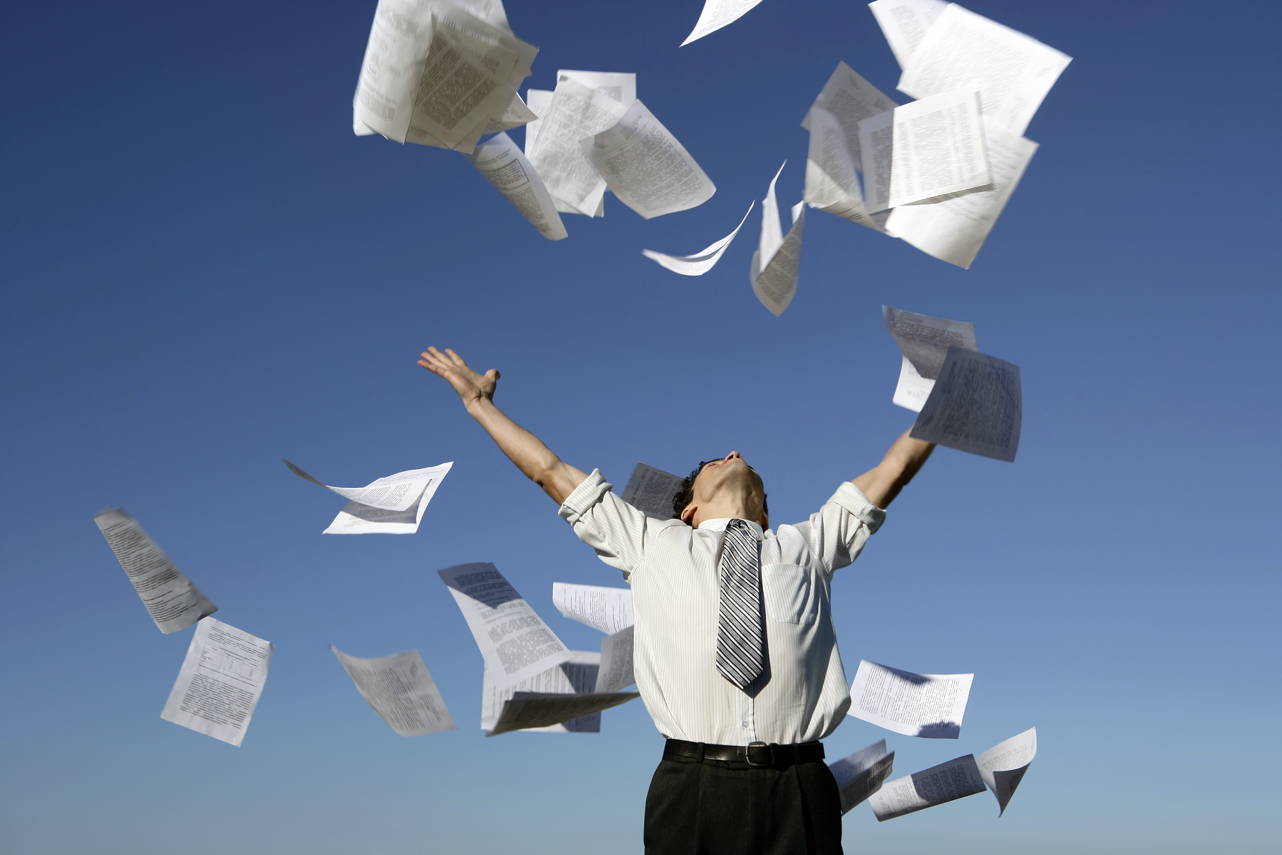 Businessman throwing papers into the air