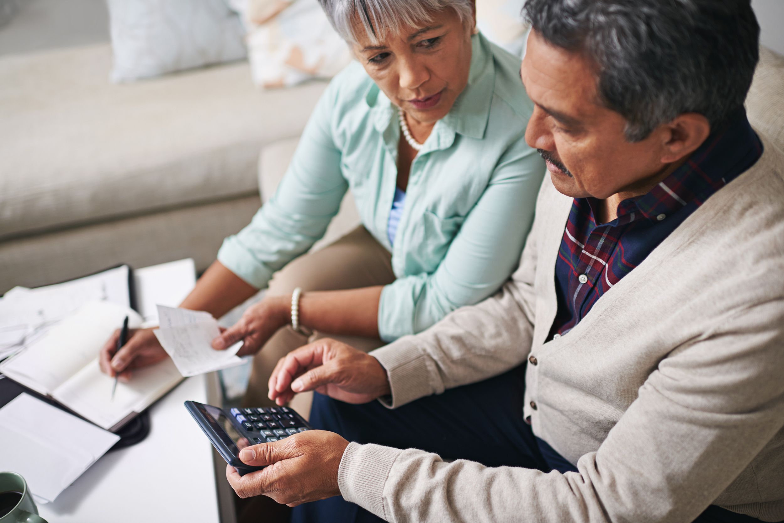 senior couple doing budgeting in living room