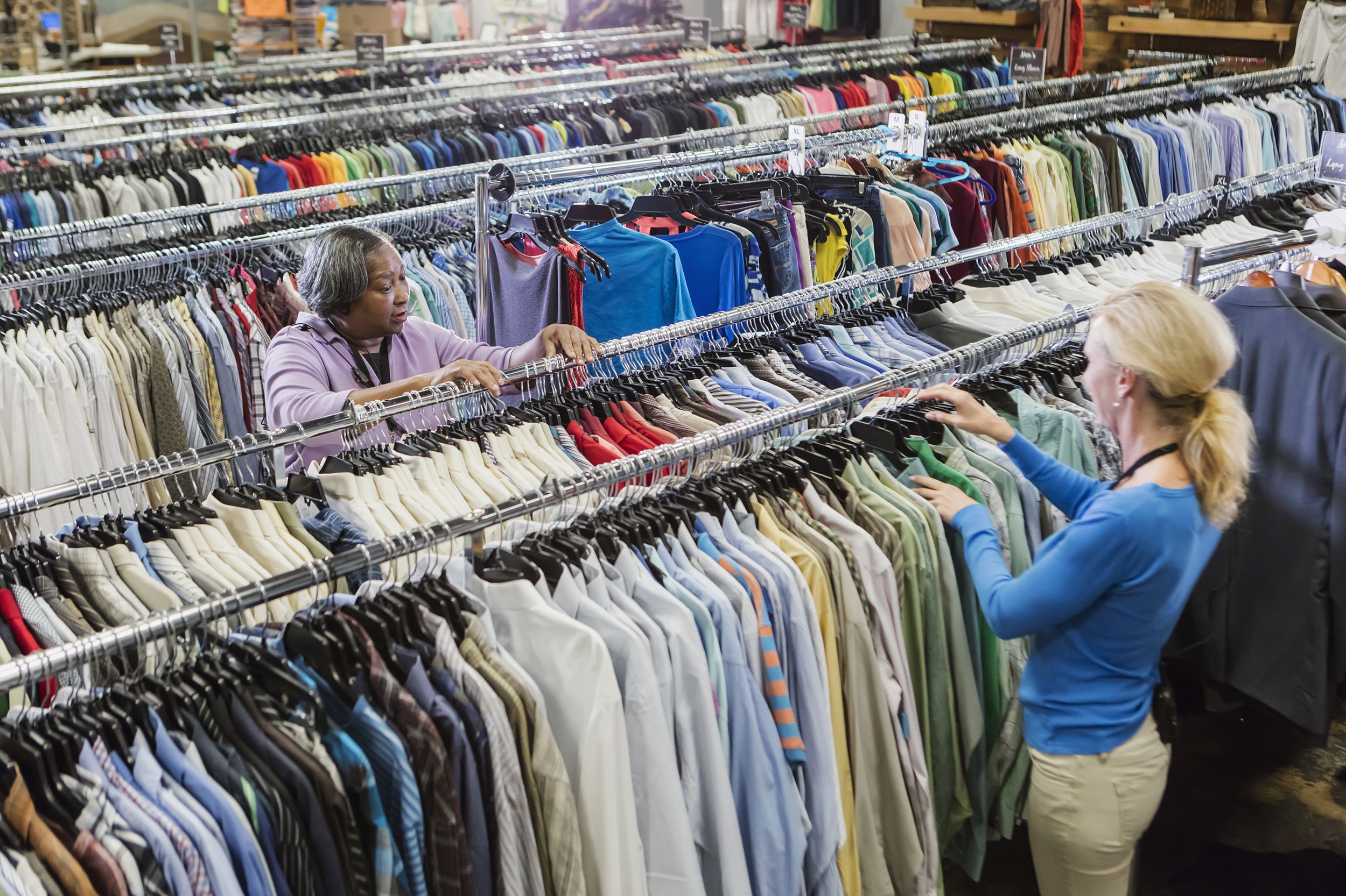 two women working in clothing goodwill store