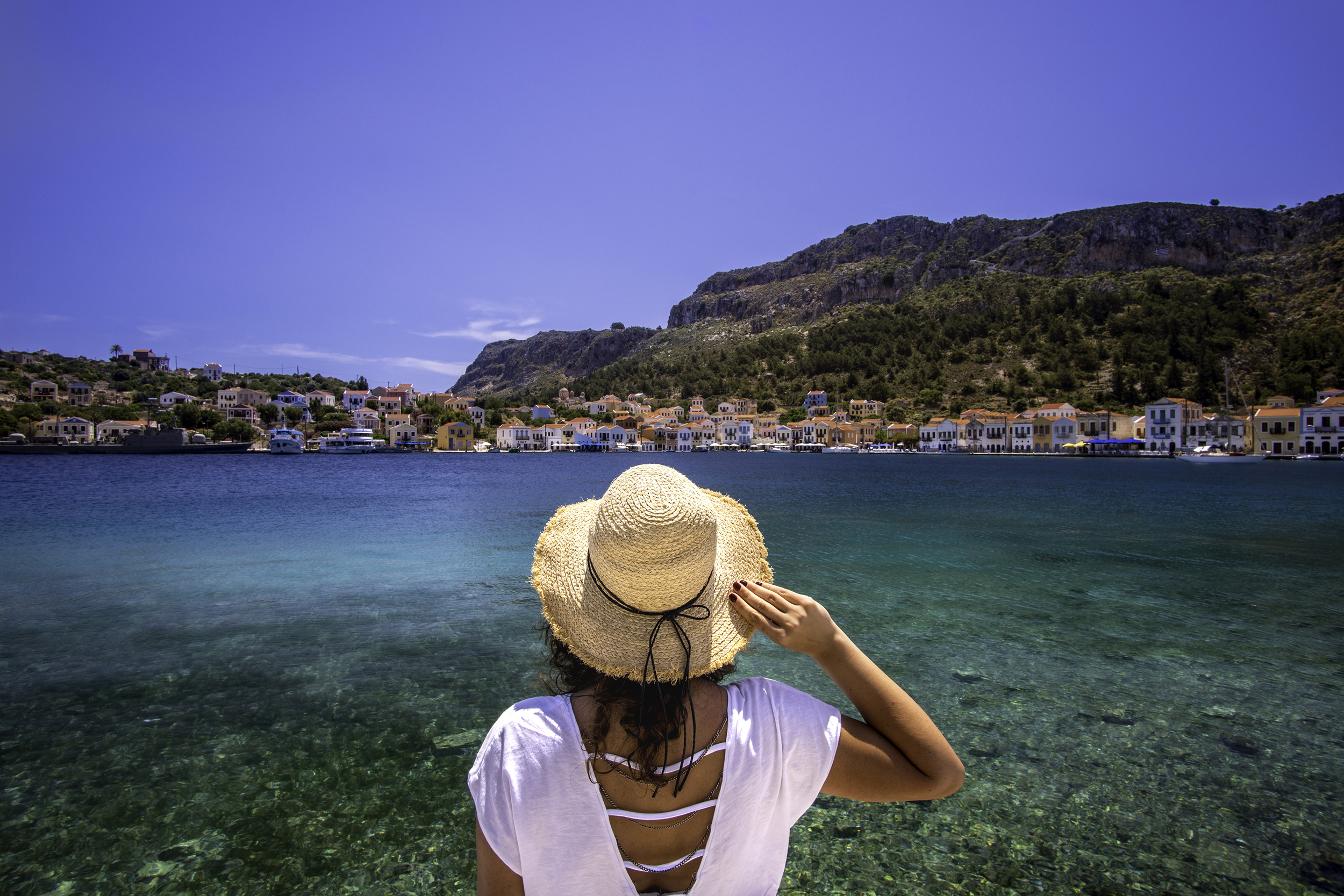 Woman looking across the sea in Greece
