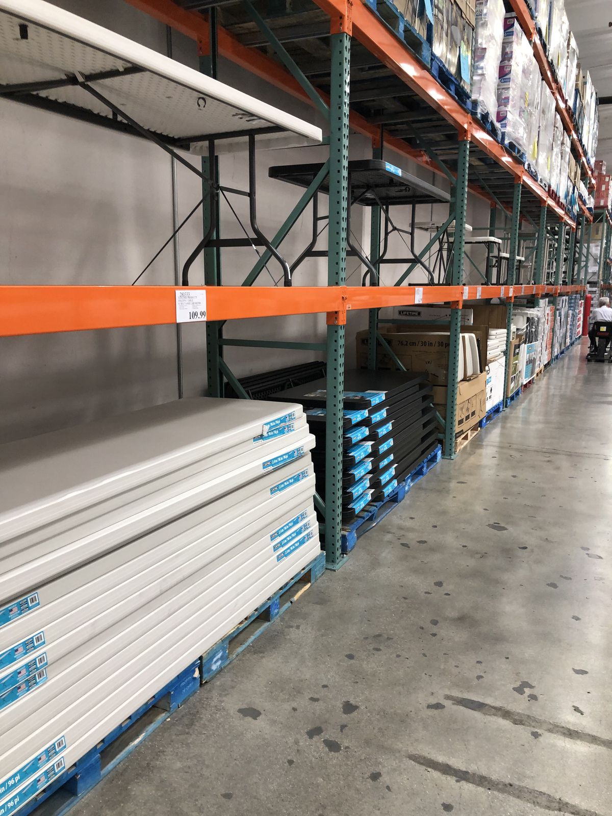 A Costco Business Center interior shot showing folding tables stacked.