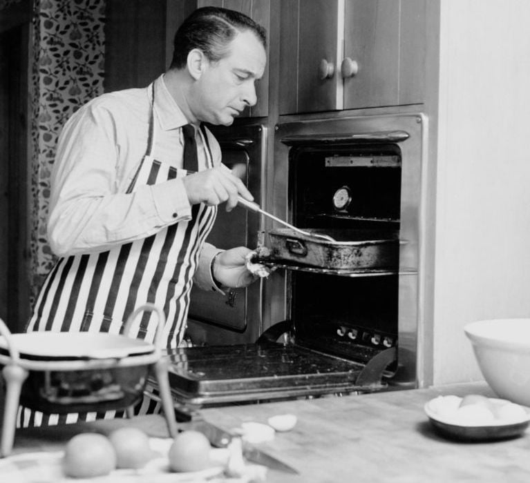 Danish actor and comedian Victor Borge (1909 - 2000) cooks at meal at his home in Southbury, Connecticut, circa 1955.
