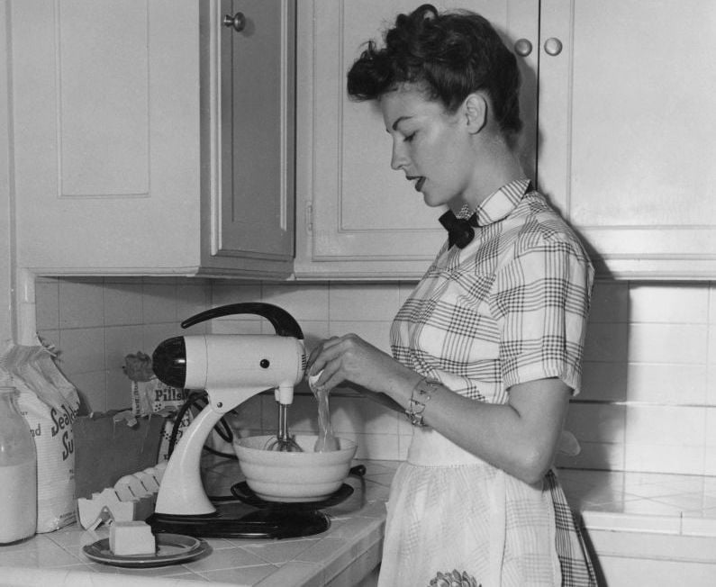 American actress and singer Ava Gardner (1922 - 1990) cooking at home, 28th October 1952.