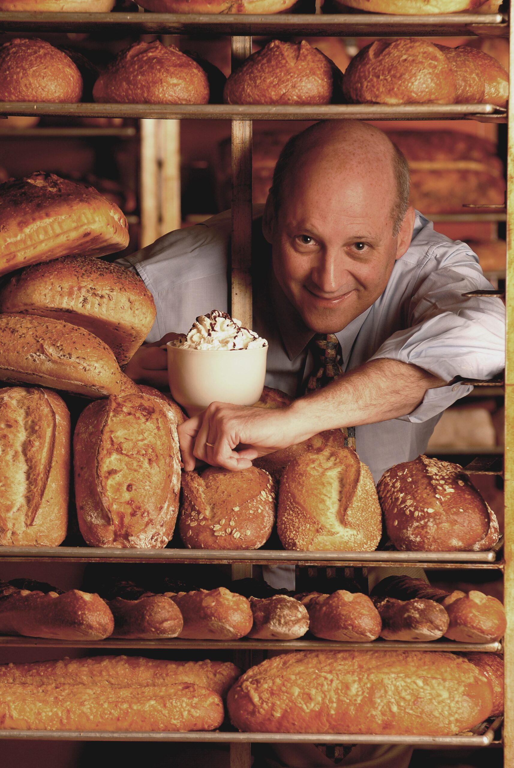 Ron Shaich, co-founder of Panera Bread Co., pictured surrounded by loaves of bread, in 2006.