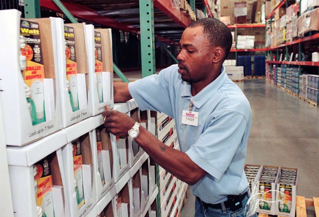 Costco worker Troy Watson re-stocks low energy lightbulbs inside Costco Store, March 29, 2001 in Culver City, California.