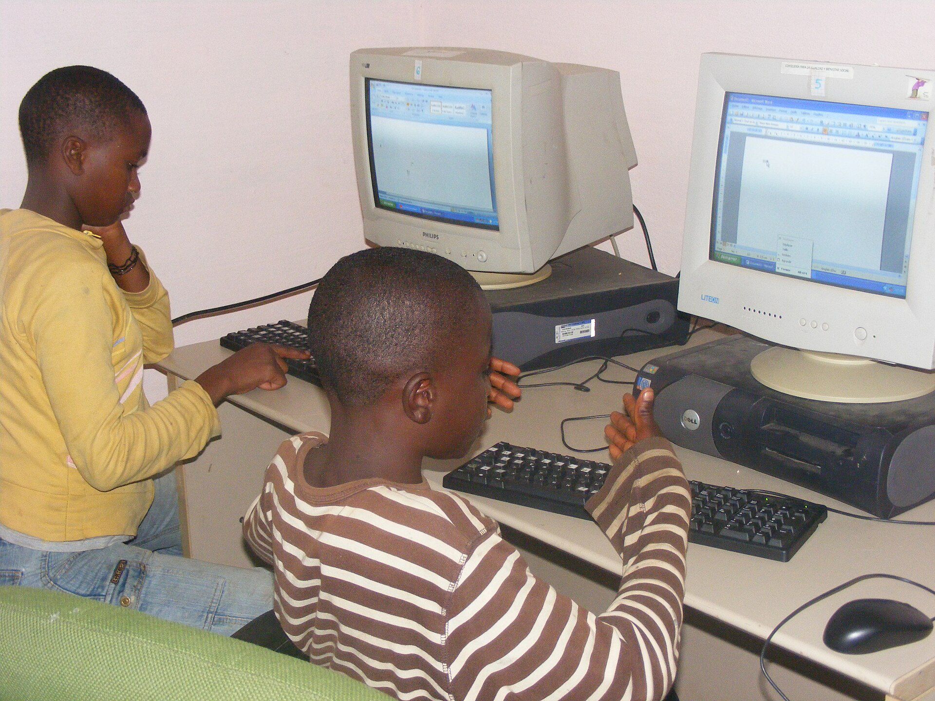 Two students on computers using Microsoft Word