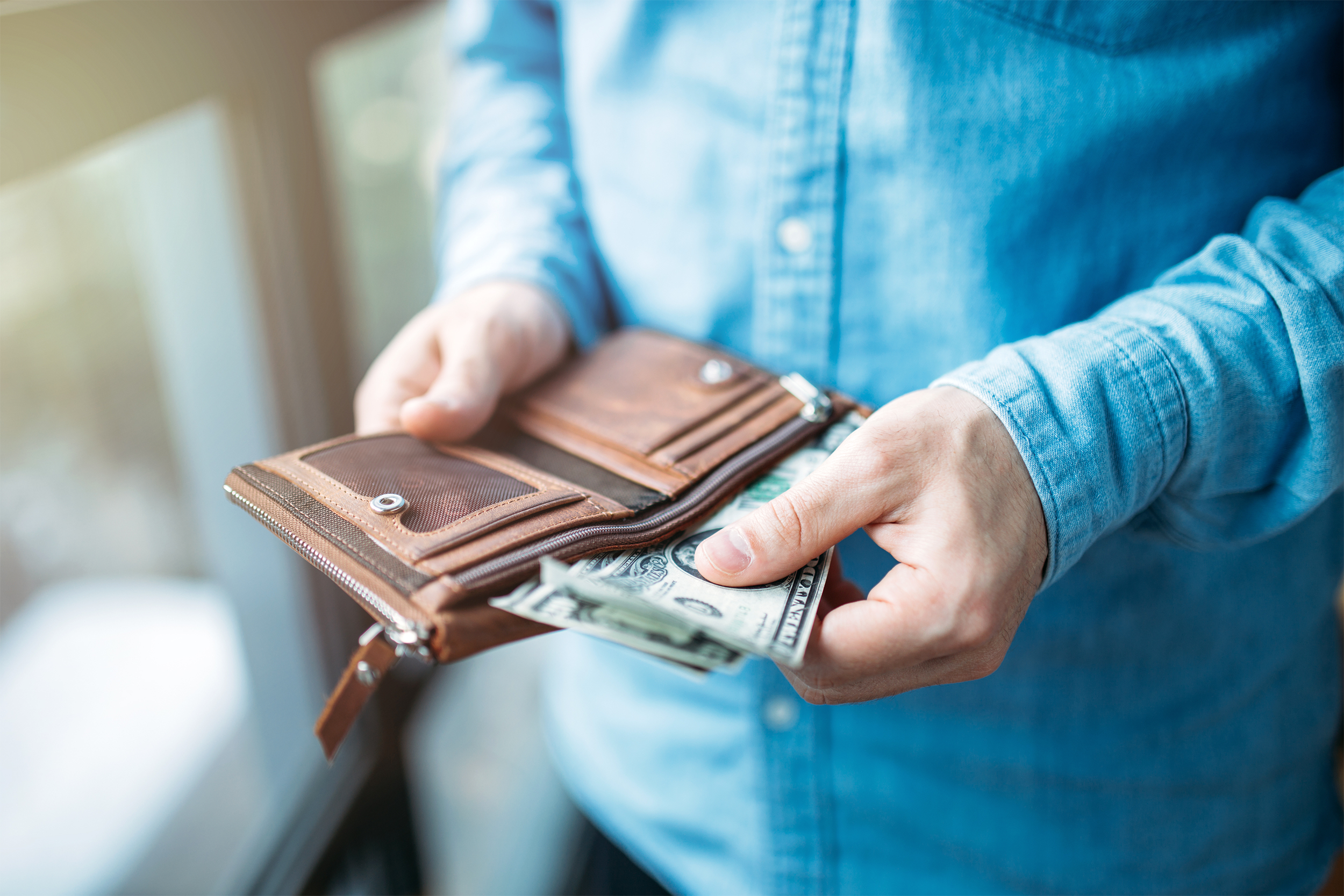 pulling money out of a wallet