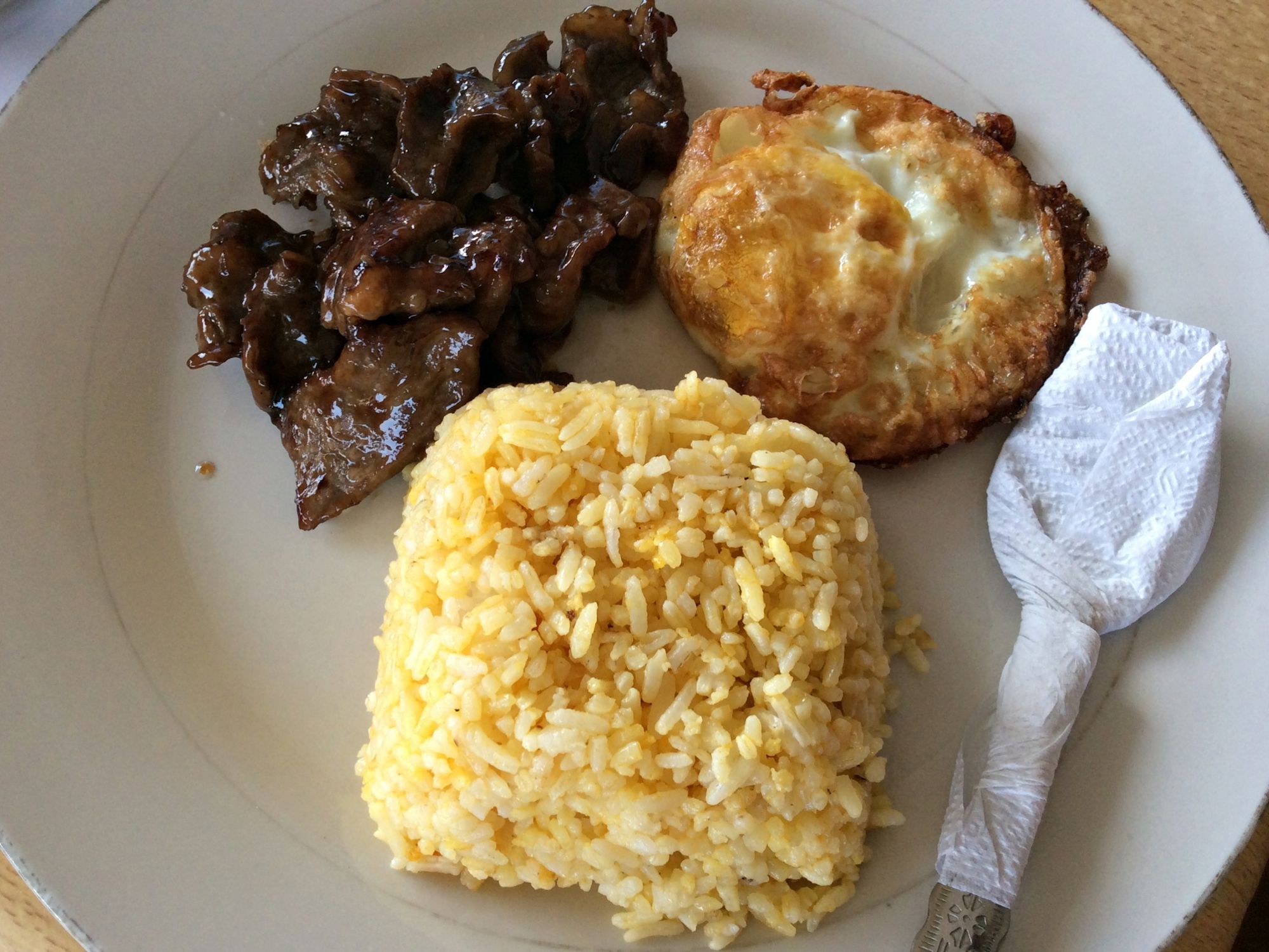 Tapsilog which is short for Tapa (cured beef), sinangag (fried rice) and itlog (egg) in one plate is one of the most popular budget meals in the Philippines.