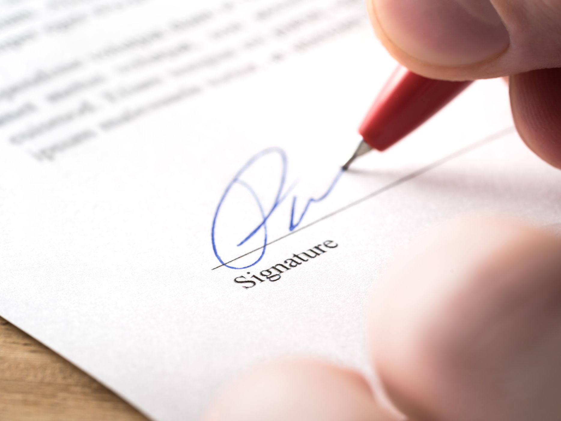 Signing contract, lease or settlement for acquisition, apartment lease, insurance, bank loan, mortgage or business buyout. Man writing name and autograph with pen. The signature is made up. Macro.