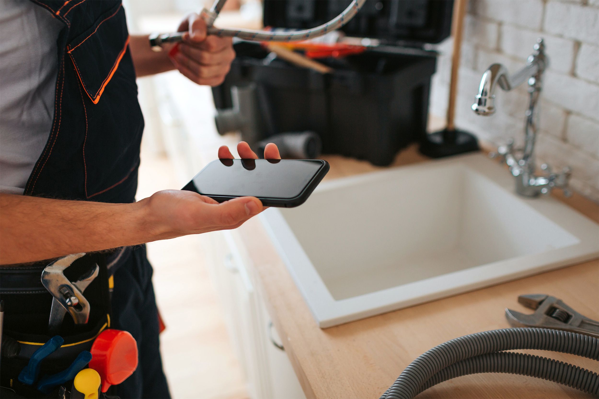 plumber looking at his phone
