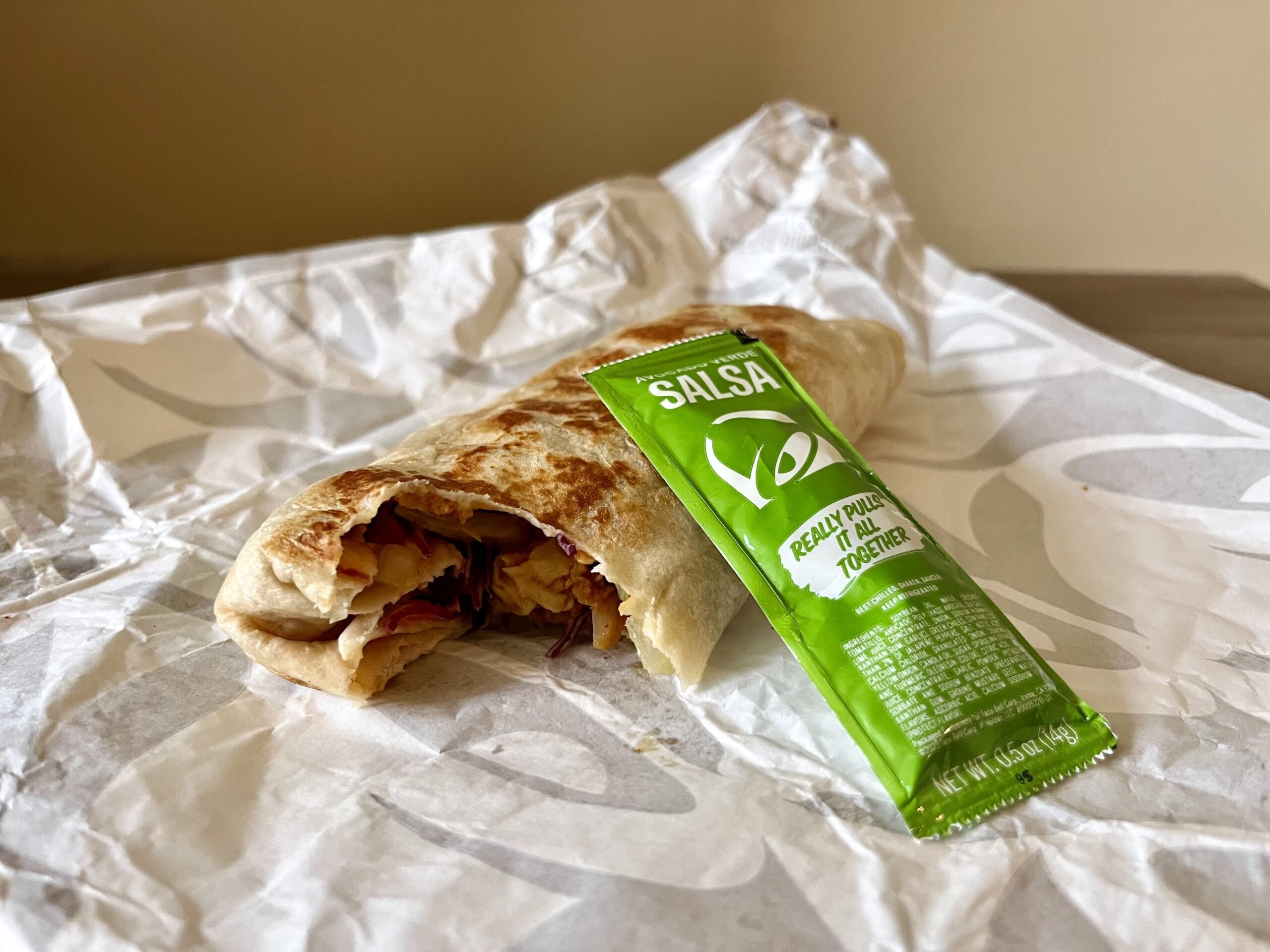 taco bell Cantina Chicken Burrito with a packet of salsa verde