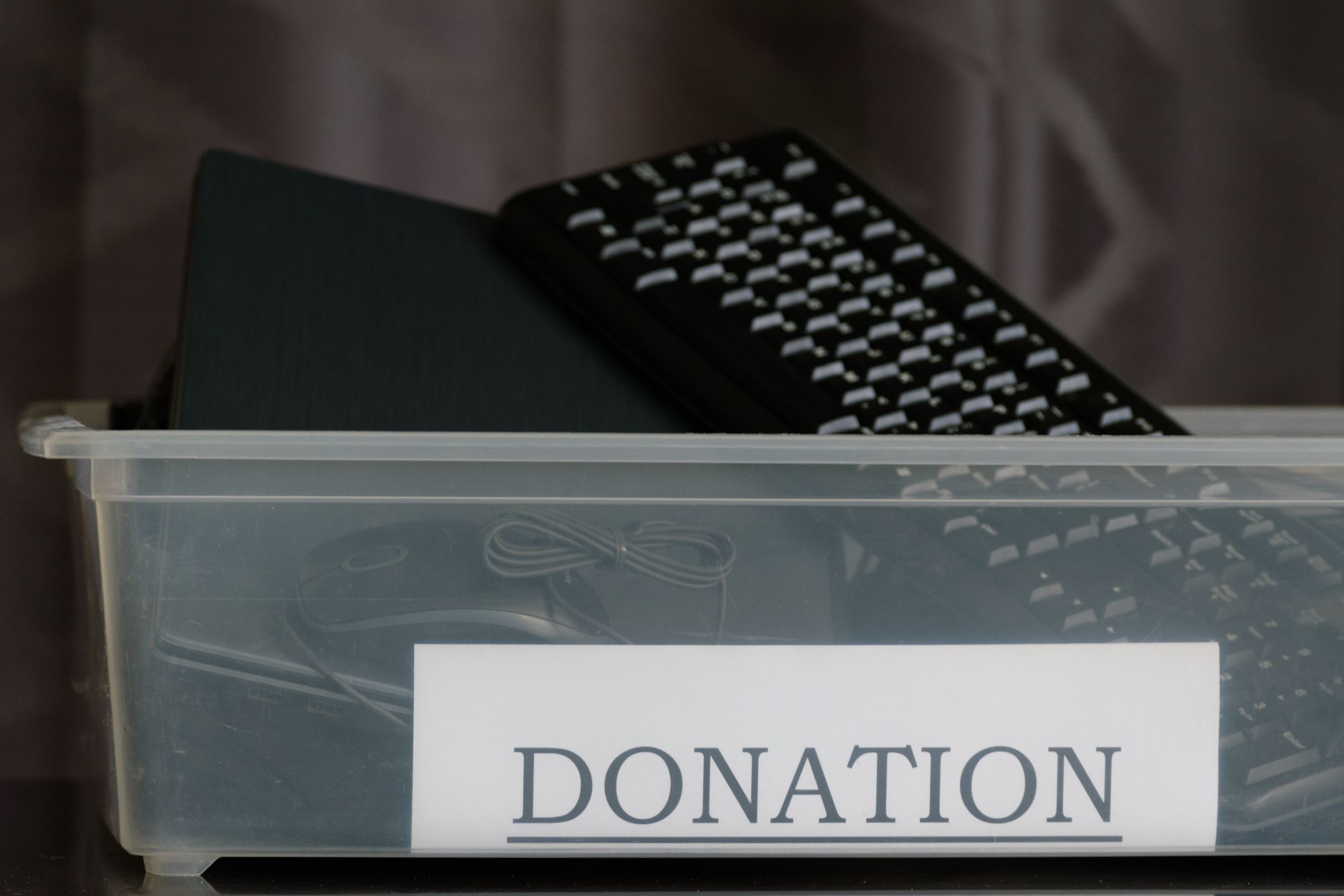 The box contains a keyboard, laptop and computer mouse