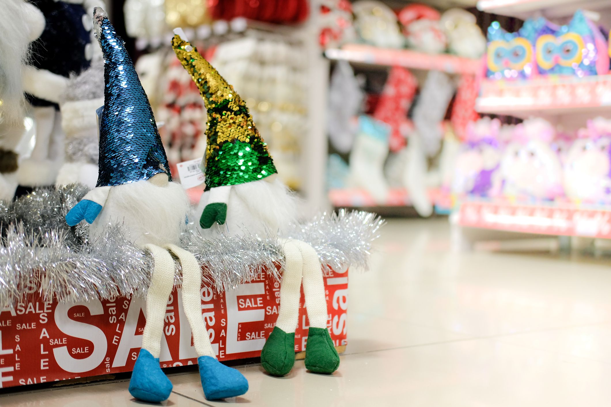 Festive toys close-up on sale. Blurred christmas shop windows