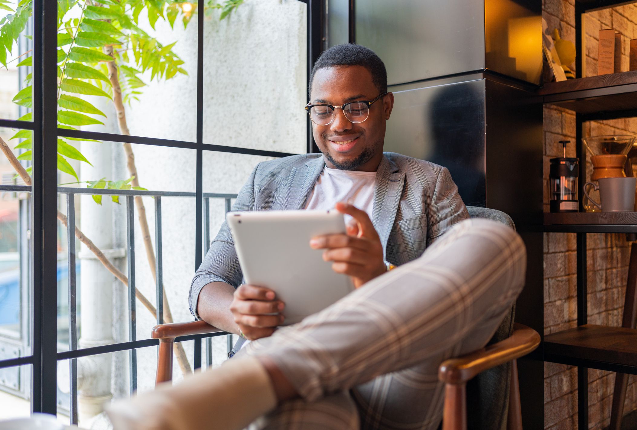 An African Young Man Working On Digital Tablet At Coffee Shop