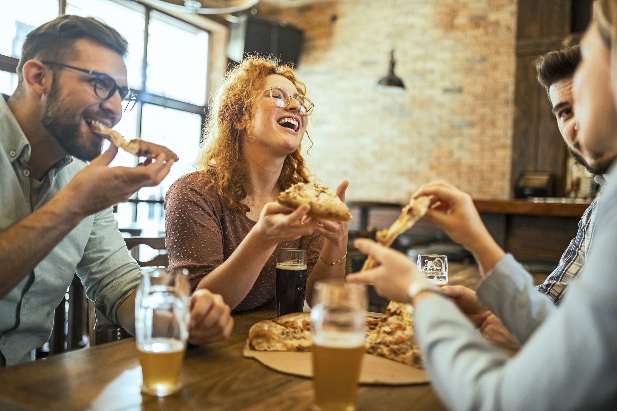 Young people enjoying time together and having pizza