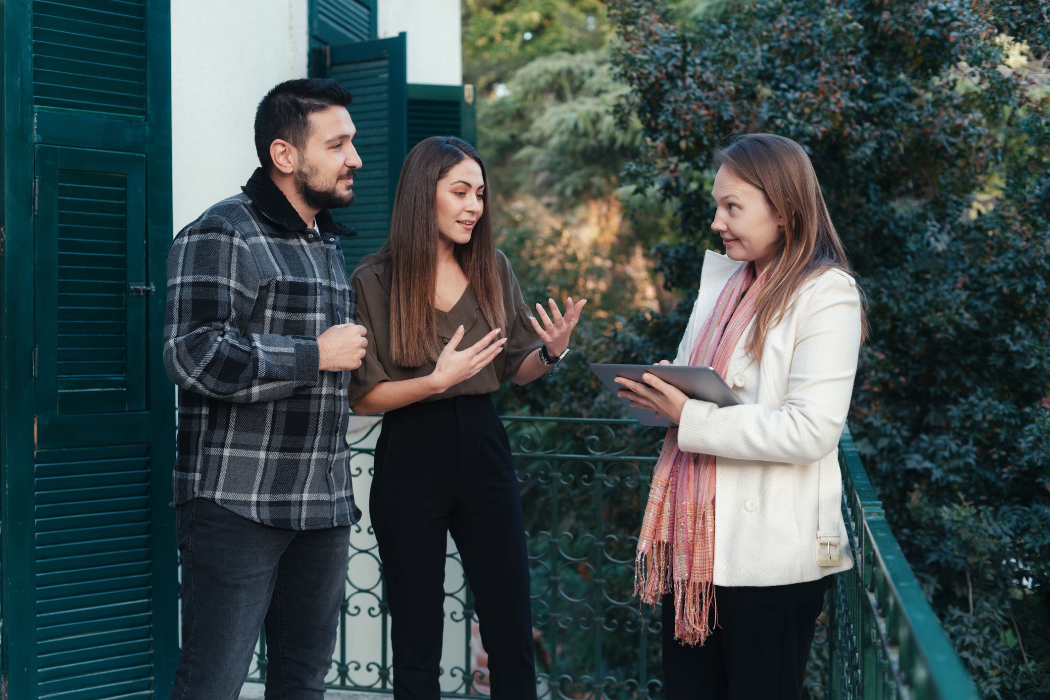 Real estate agent with a young couple in a new house