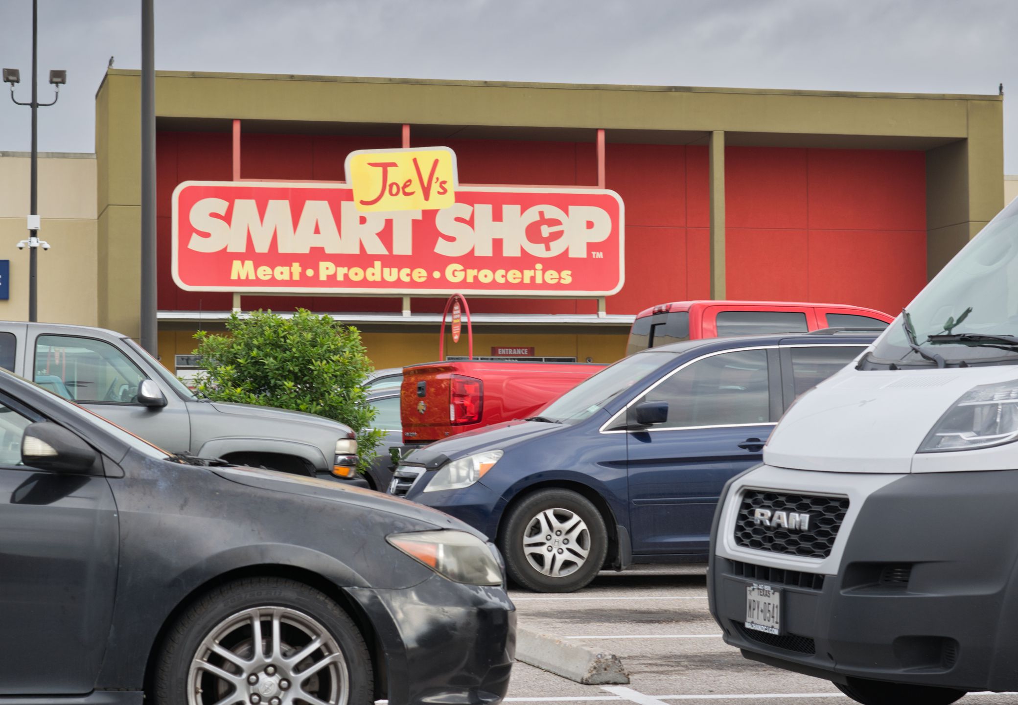 Houston, Texas USA 12-03-2021: Joe V`s Smart Shop exterior and parking lot in Houston, TX. Small local supermarket chain store.