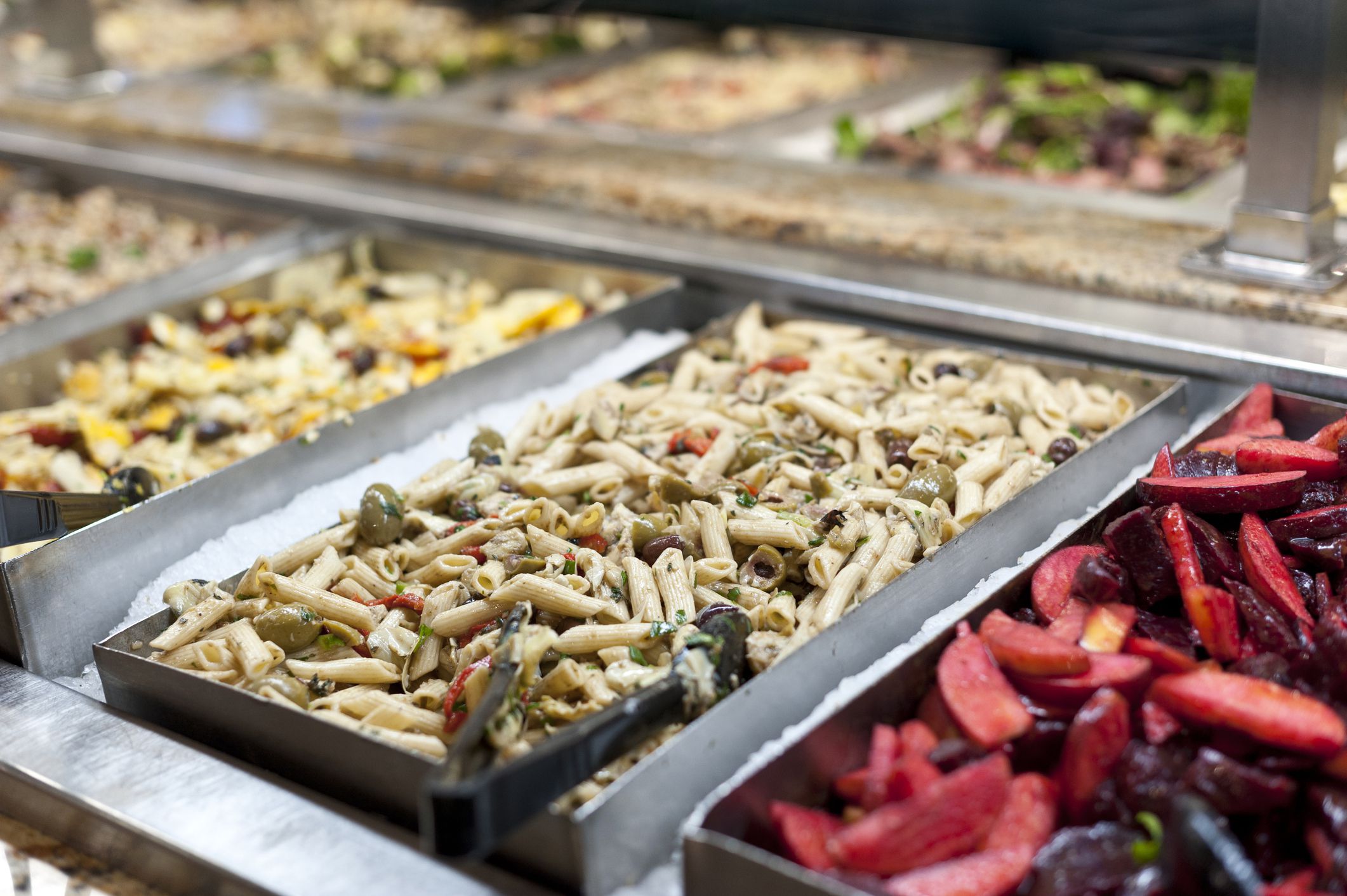 Close up pictures of trays full of italian pasta dishes