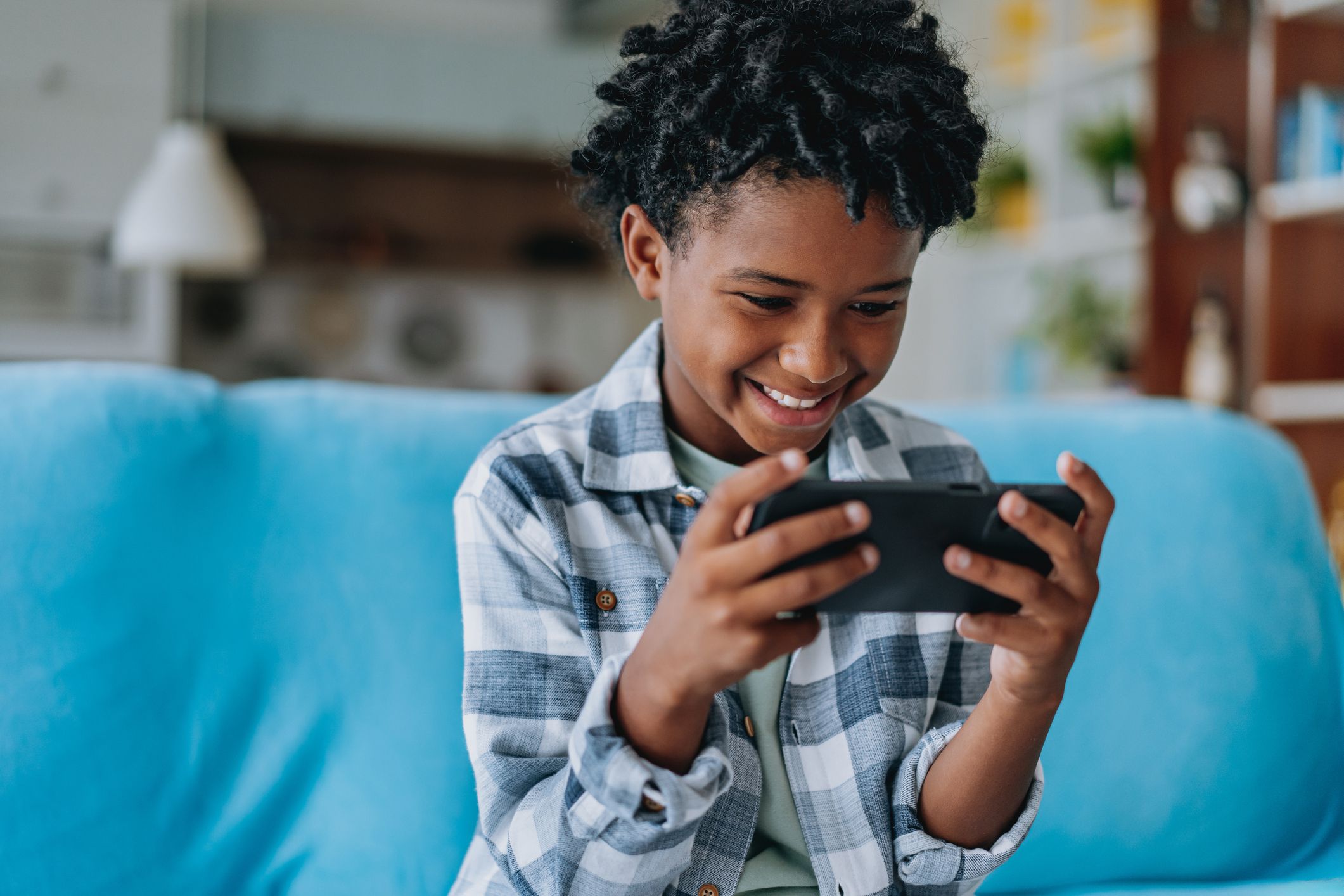 Black boy child using smartphone