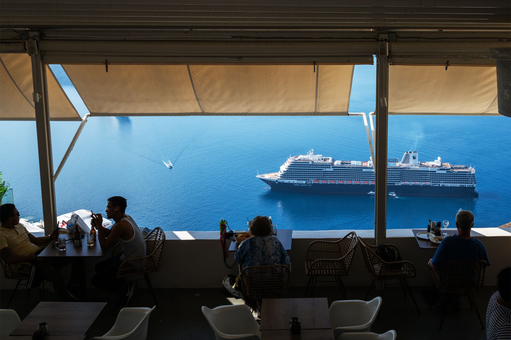 Santorini, Greece - August 16, 2015: Unidentified tourists sitting in traditional Greek taverns on peaceful afternoon in Fira