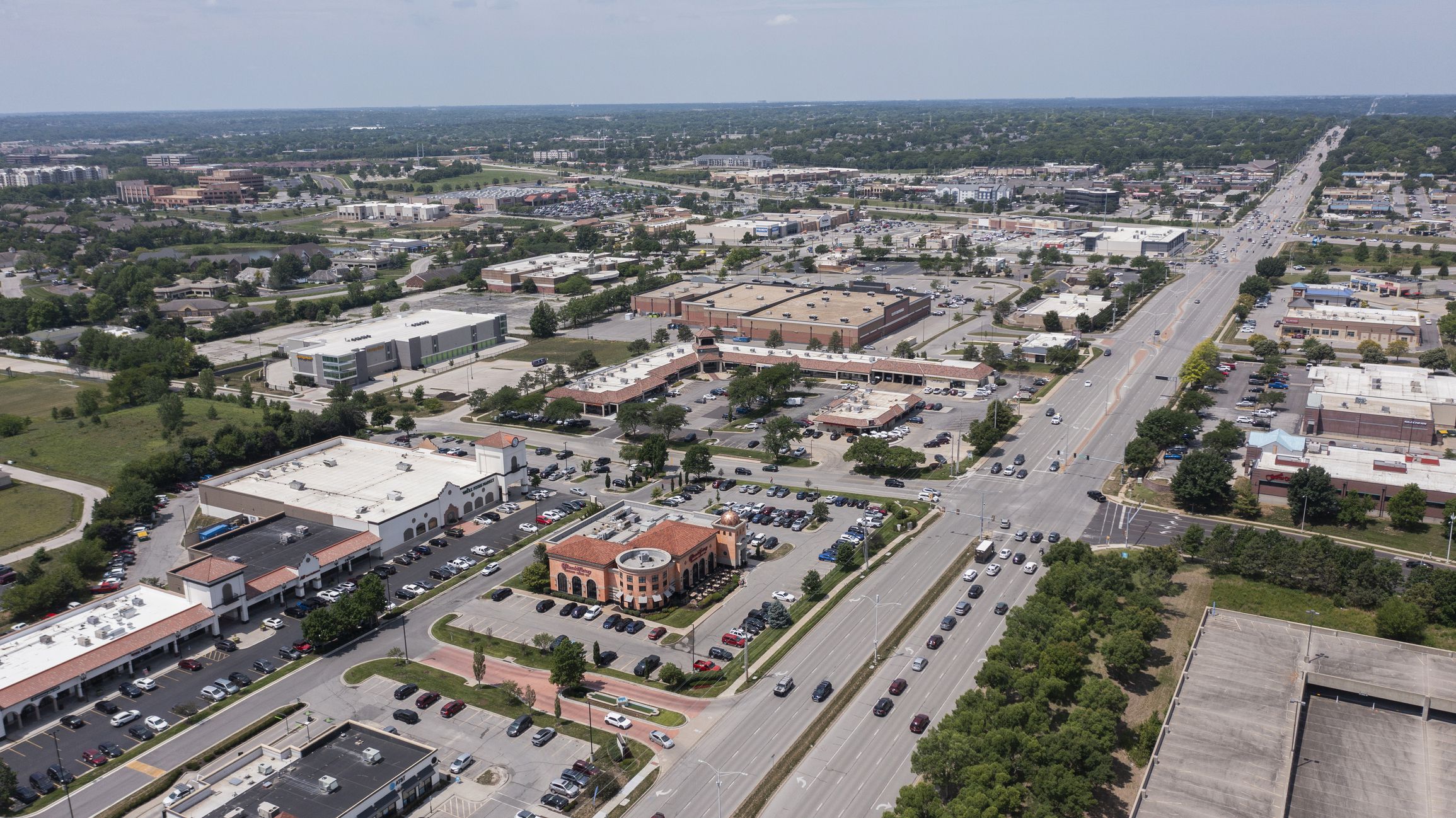 Overland Park, Kansas, USA - June 17, 2023: Morning traffic passes through the downtown commercial district of Overland Park.