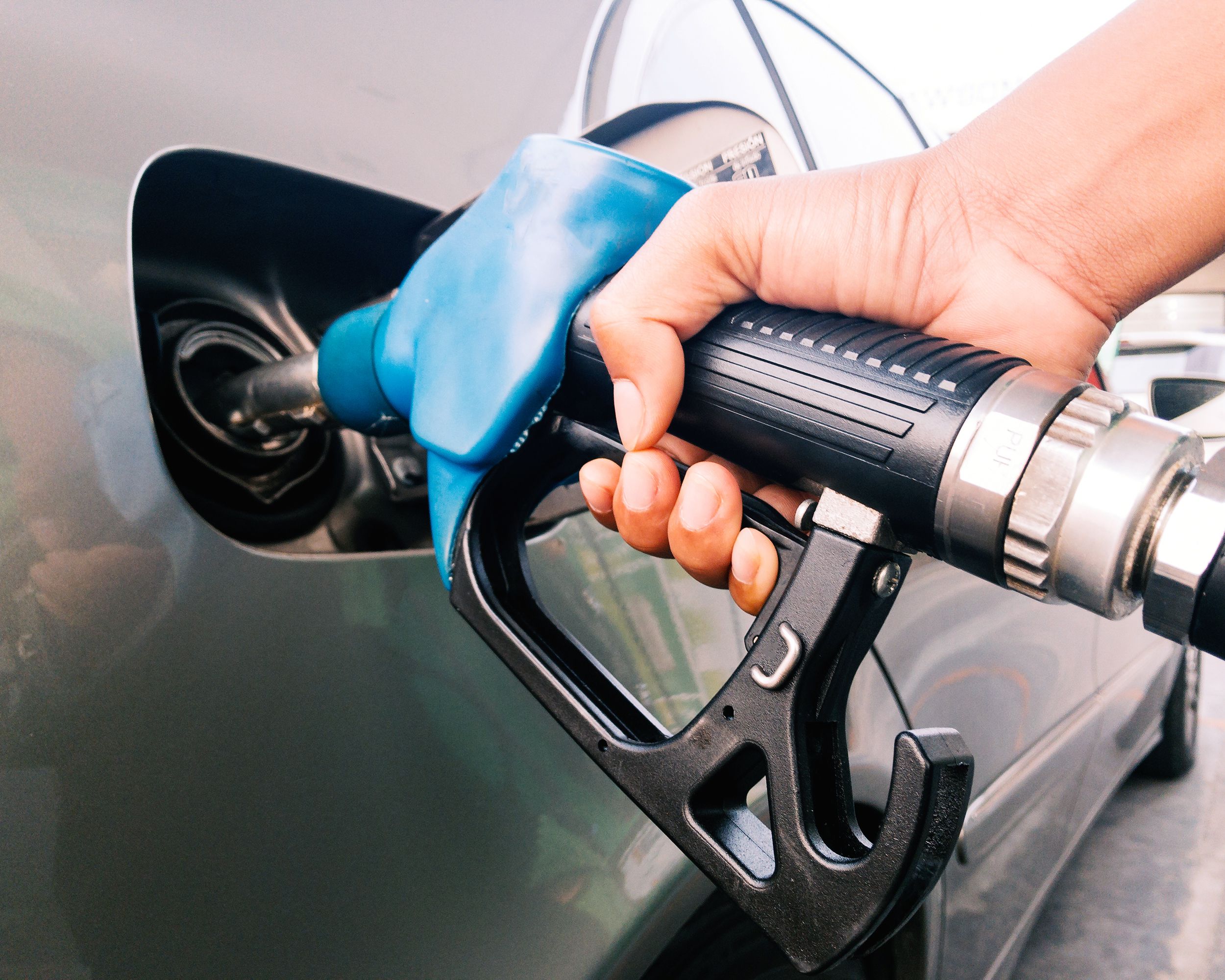 hand holding gasoline nozzle