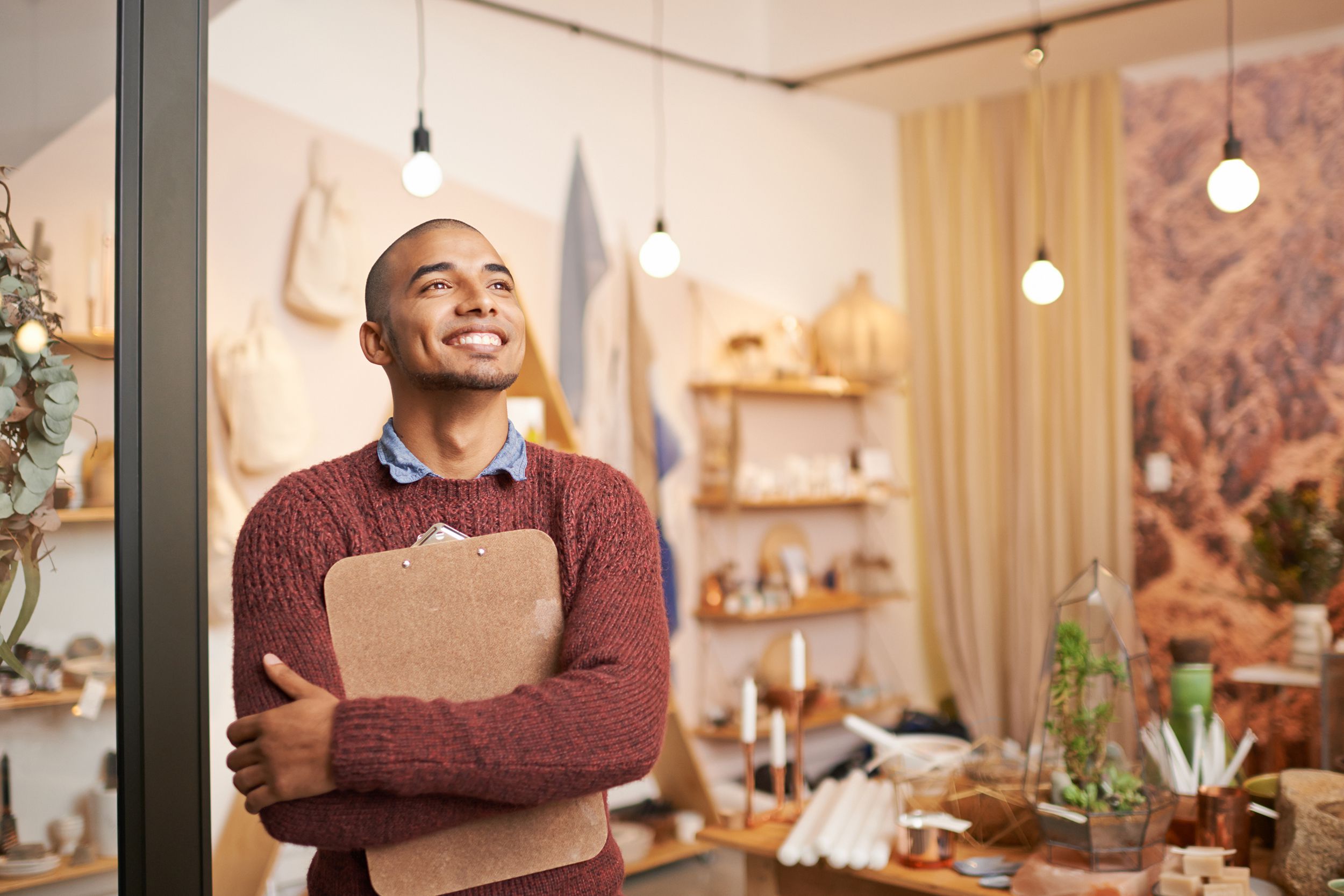 man smiling in his small business shop