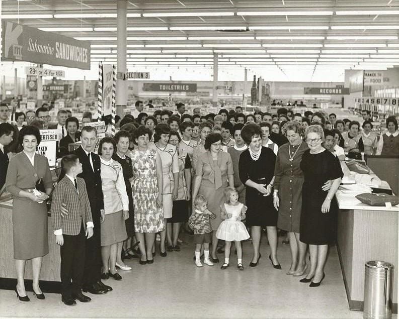 A large group of people at an opening of a new Kmart in the 1960s