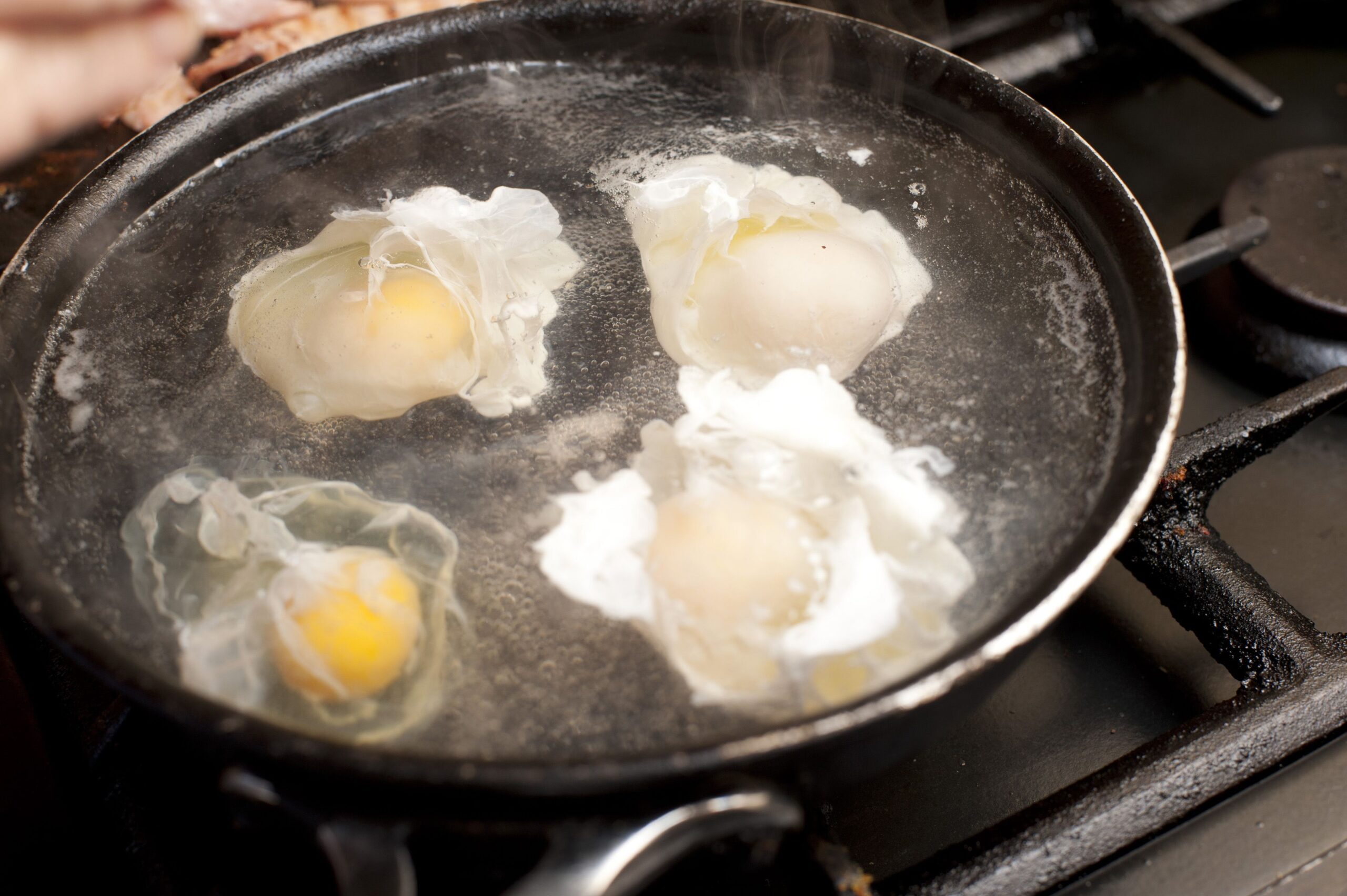 eggs poaching in a pan